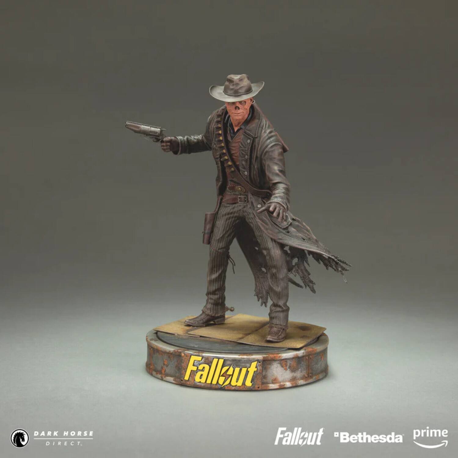 The text on the image should be grouped and corrected as follows:

- "Fallout" (on the base of the figure)
- "Fallout" (in the bottom right corner)
- "Bethesda prime" (in the bottom right corner)
- "DARK HORSE DIRECT" (in the bottom left corner)

The corrected text is:

- "Fallout"
- "Fallout"
- "Bethesda prime"
- "DARK HORSE DIRECT"
