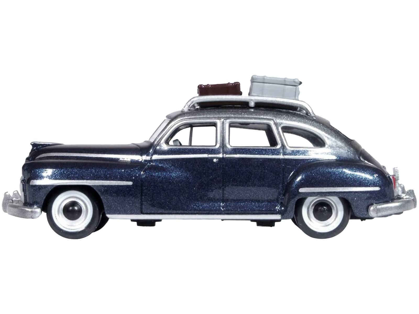 Angle. Oxford Diecast - 1946 DeSoto Suburban with Roof Rack and Luggage Butterfly Blue Metallic with Crystal Gray Top 1/87 (HO) Scale - Blue Metallic, Gray.