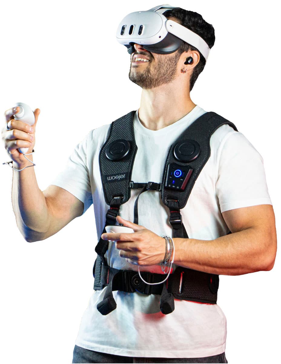 The man is wearing a woojer vest, which is a device that enhances the gaming experience by providing additional sensory feedback. He is also wearing a headset and holding a Wii controller, indicating that he is playing a video game.