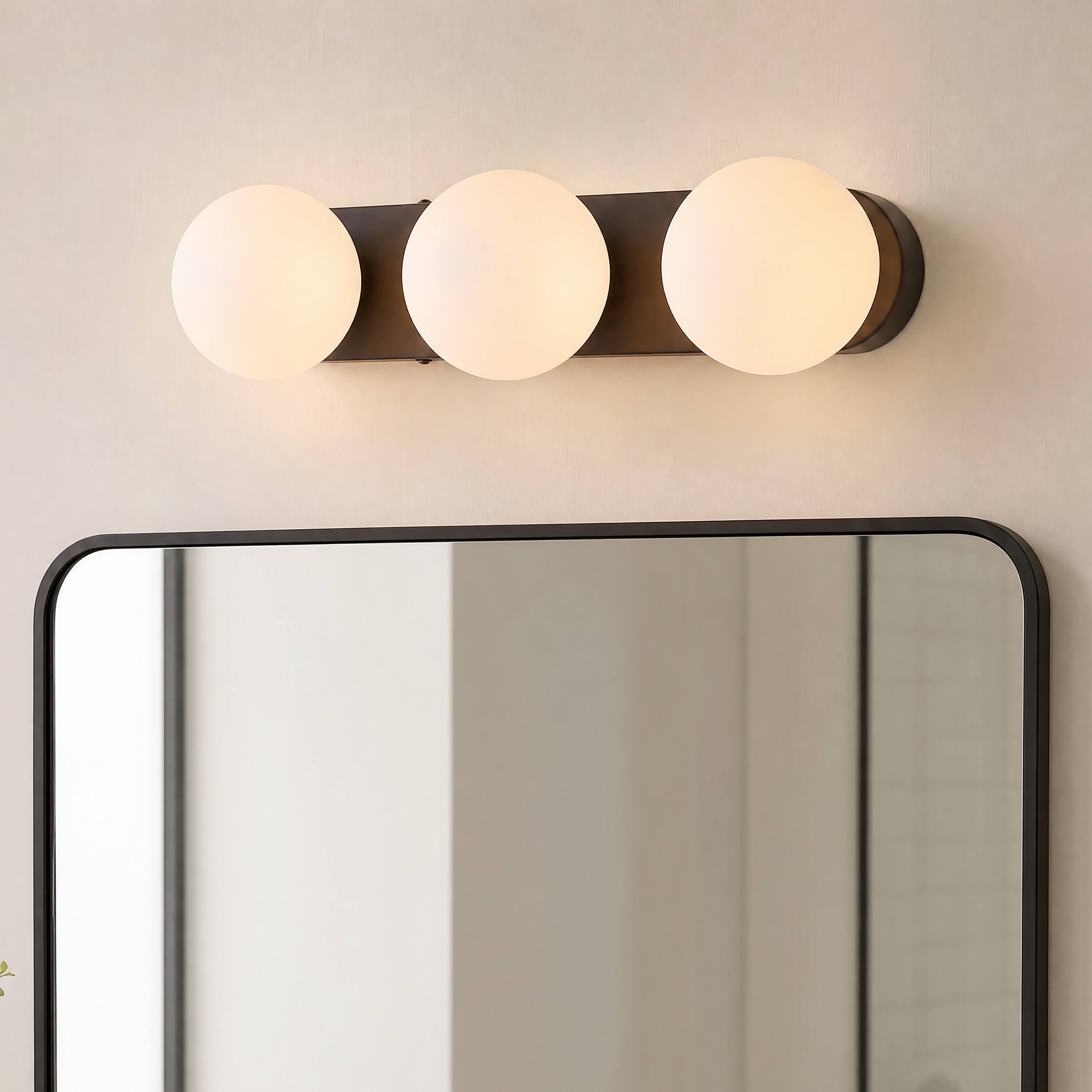 Alt View 1. Jonathan Y - Knox 23.25" 3-Light Oil Rubbed Bronze Mid-Century Modern Metal Bathroom Vanity Light with White Glass Globe Shades - Oil Rubbed Bronze.