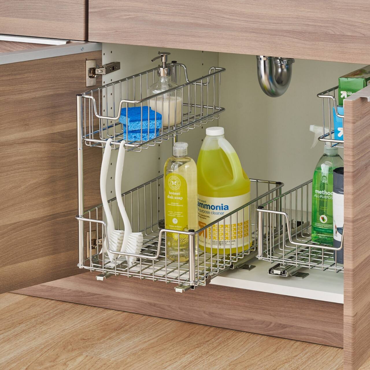 The image shows a shelf with various cleaning supplies, including a bottle of ammonia cleaner and a bottle of method all-purpose cleaner. The shelf is located under a sink, and the cleaning supplies are organized neatly on the shelf.
