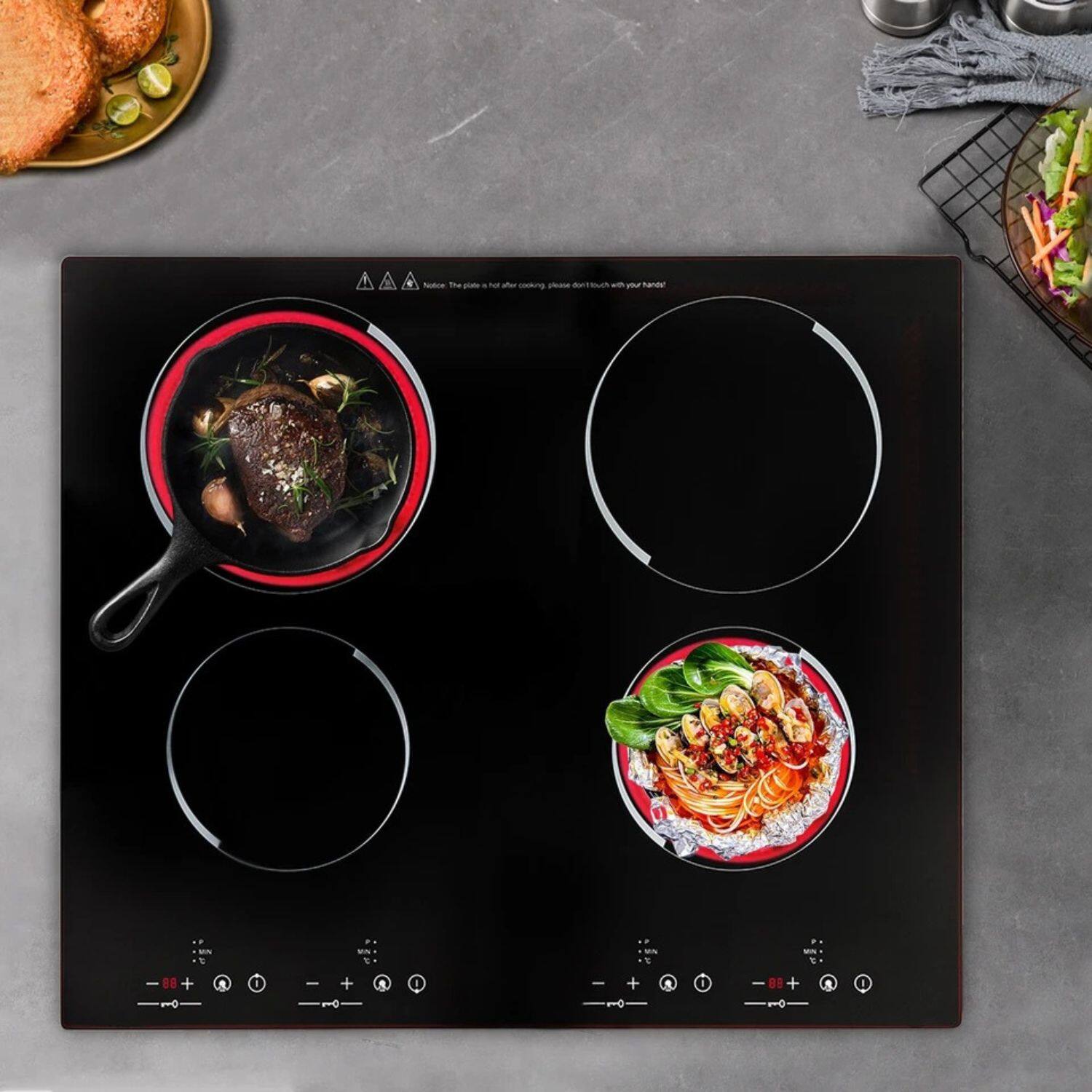 The image shows a modern induction cooktop with two cooking zones. On the left zone, there is a pot containing a piece of meat with herbs and spices. On the right zone, there is a bowl of noodles with vegetables and sauce. The cooktop has control buttons below each cooking zone.