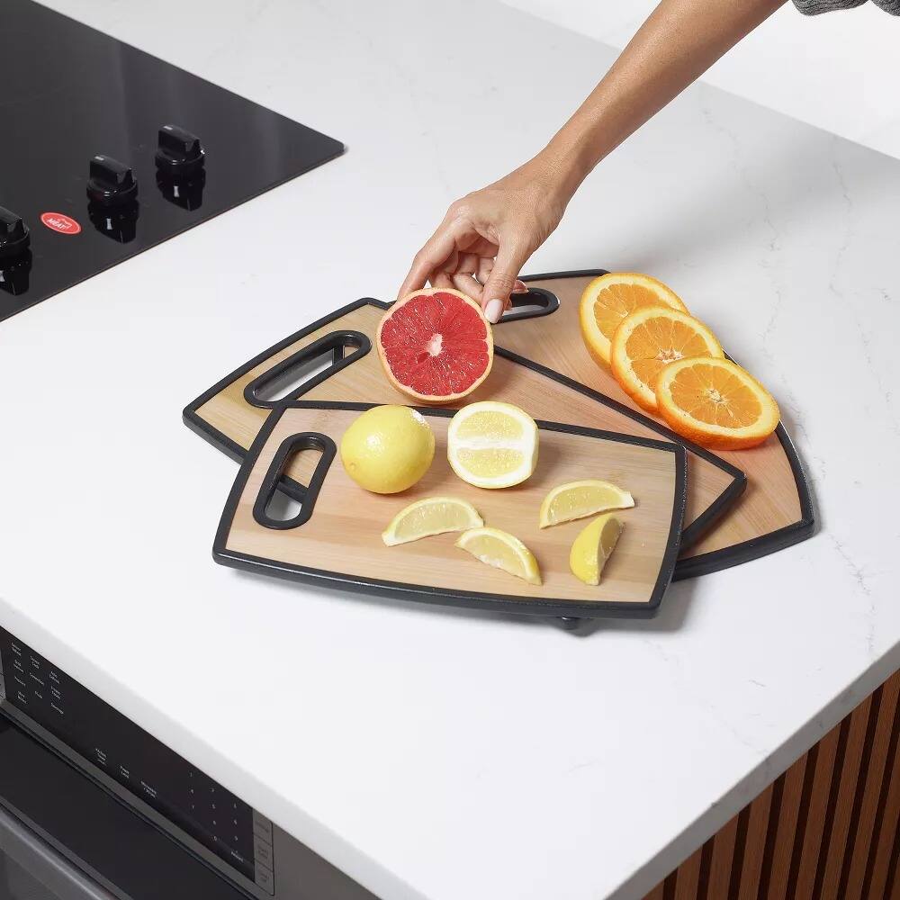 Angle. Elle Decor - 3Pc Kitchen Cutting Board Set Bamboo‑Designed Plastic, 8"×12", 9"×14", 12"×15", Nonslip Easy‑Grip Handle Dishwasher Safe - Brown.