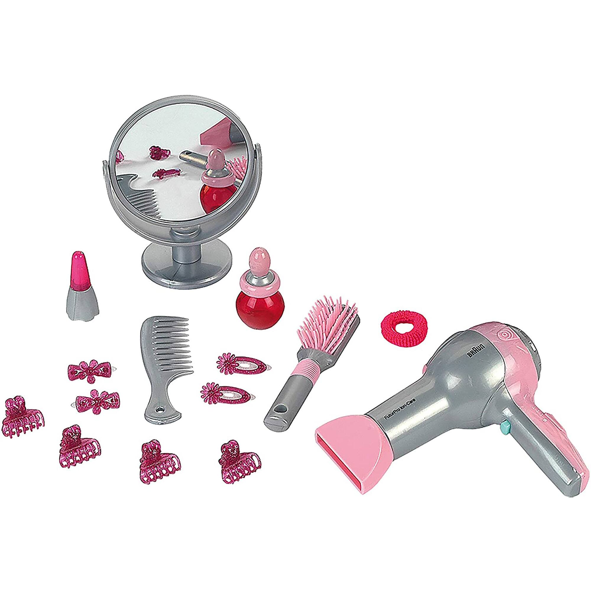 The image shows a hair styling kit with a pink hair dryer, a mirror, and various hair accessories. The hair accessories include a comb, a brush, and a hair drier. The kit is designed for a girl's hair styling needs.