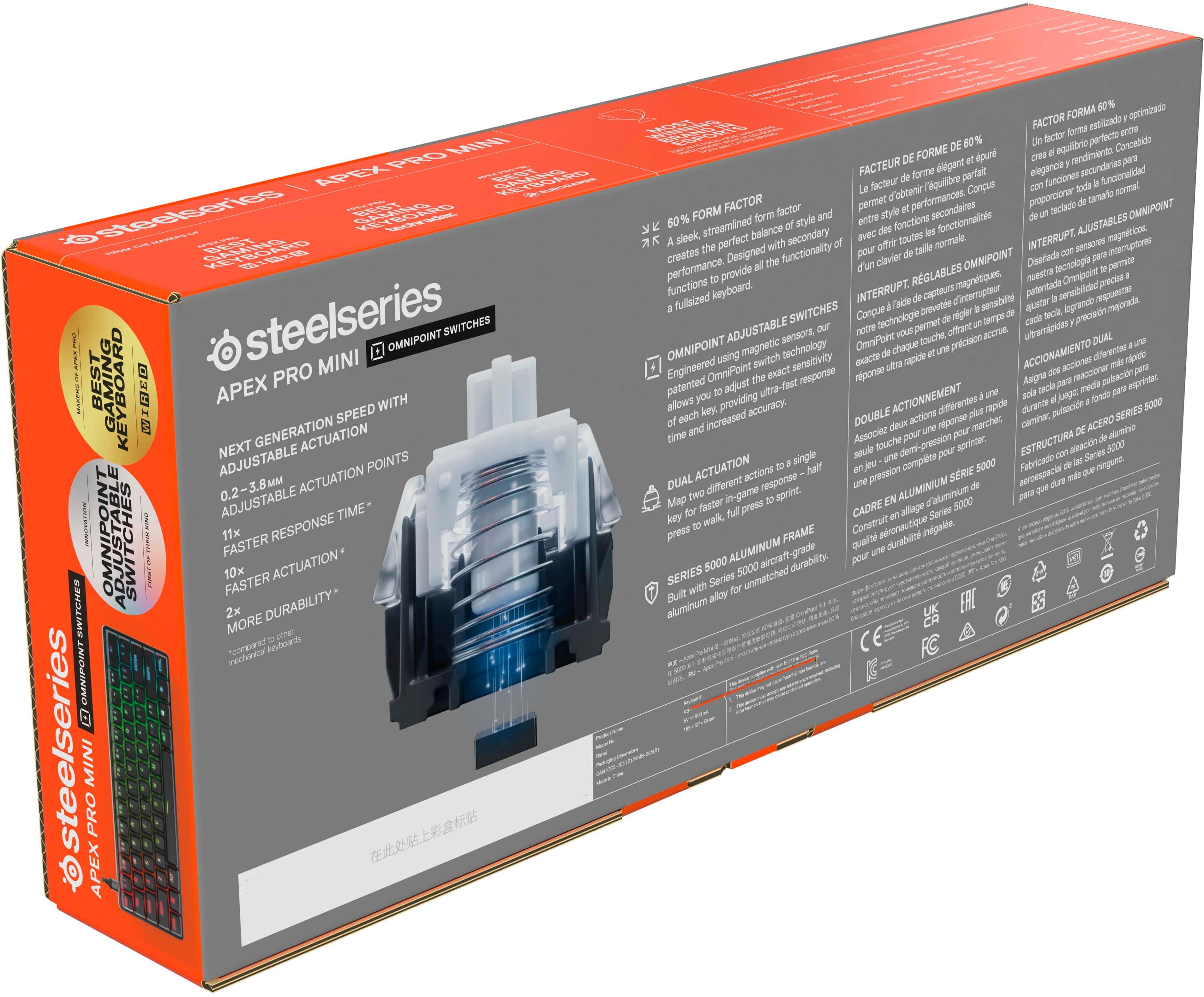 The image features a box for the Steelseries Mini Pro Keyboard. The box is orange and has a detailed description of the product on the back. The product is designed for gaming and offers a next generation actuation with adjustable actuation speed, making it suitable for competitive gaming. The box also includes a guide to help users set up the keyboard for optimal performance.