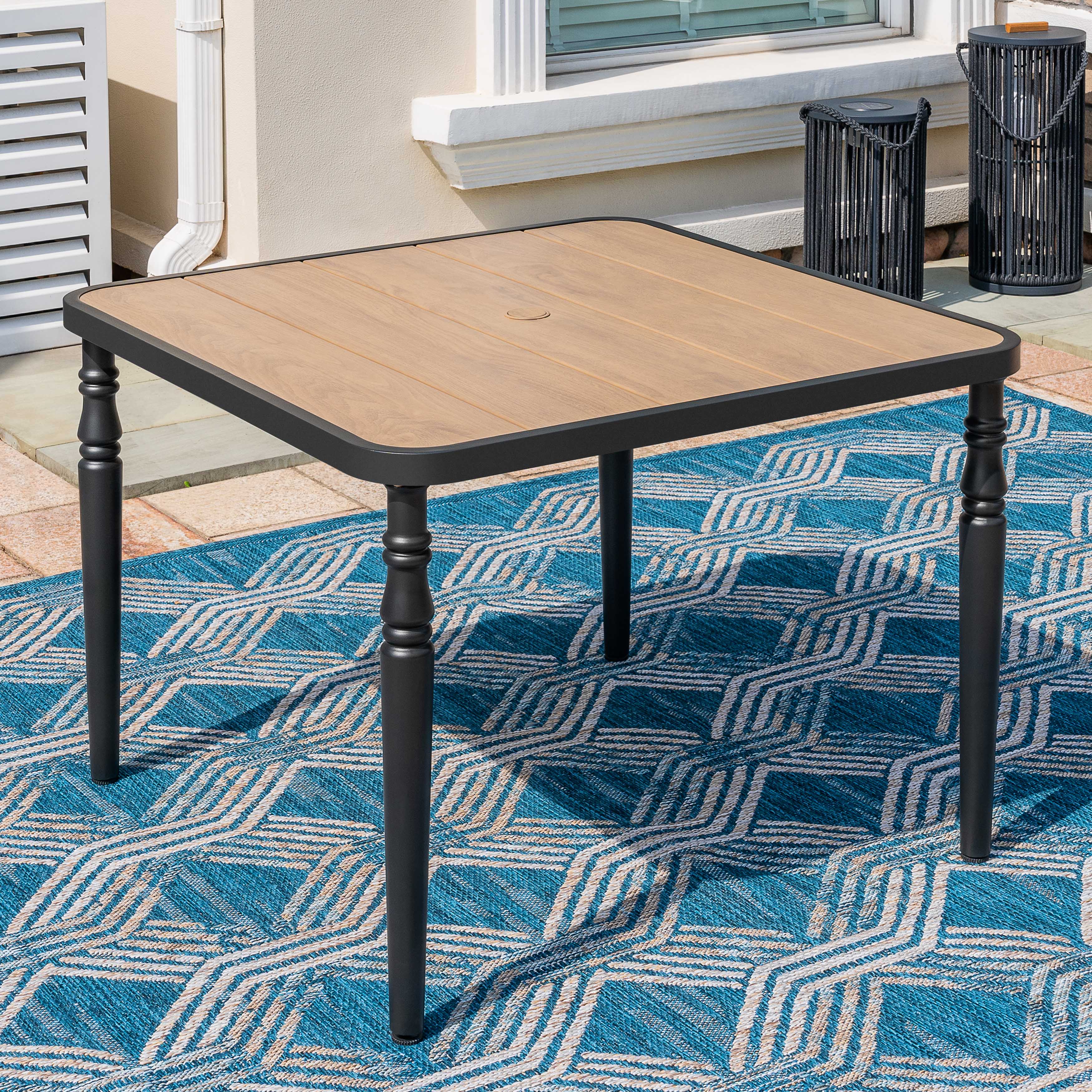 Angle. Nuu Garden - Outdoor 37" Square Metal Dining Table with 1.6'' Umbrella Hole, Wood-Grain Tabletop - Black and wood-grain finish.