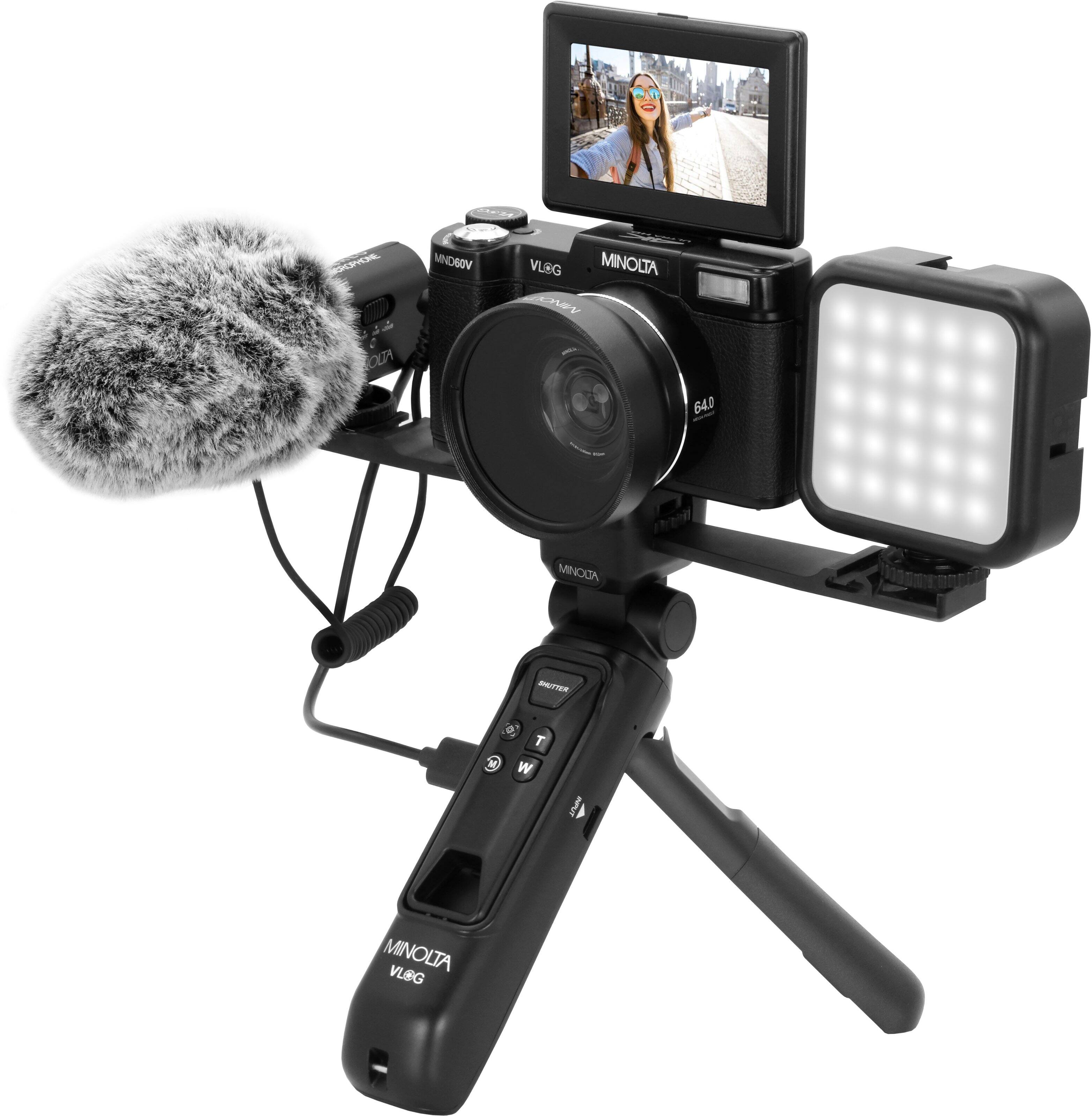 The image features a camera with a microphone attached to it, likely for a vlog. The camera is positioned on a tripod, and there is a small screen on the front of the camera. The camera is made by Minolta, and it is a CN-640 model.