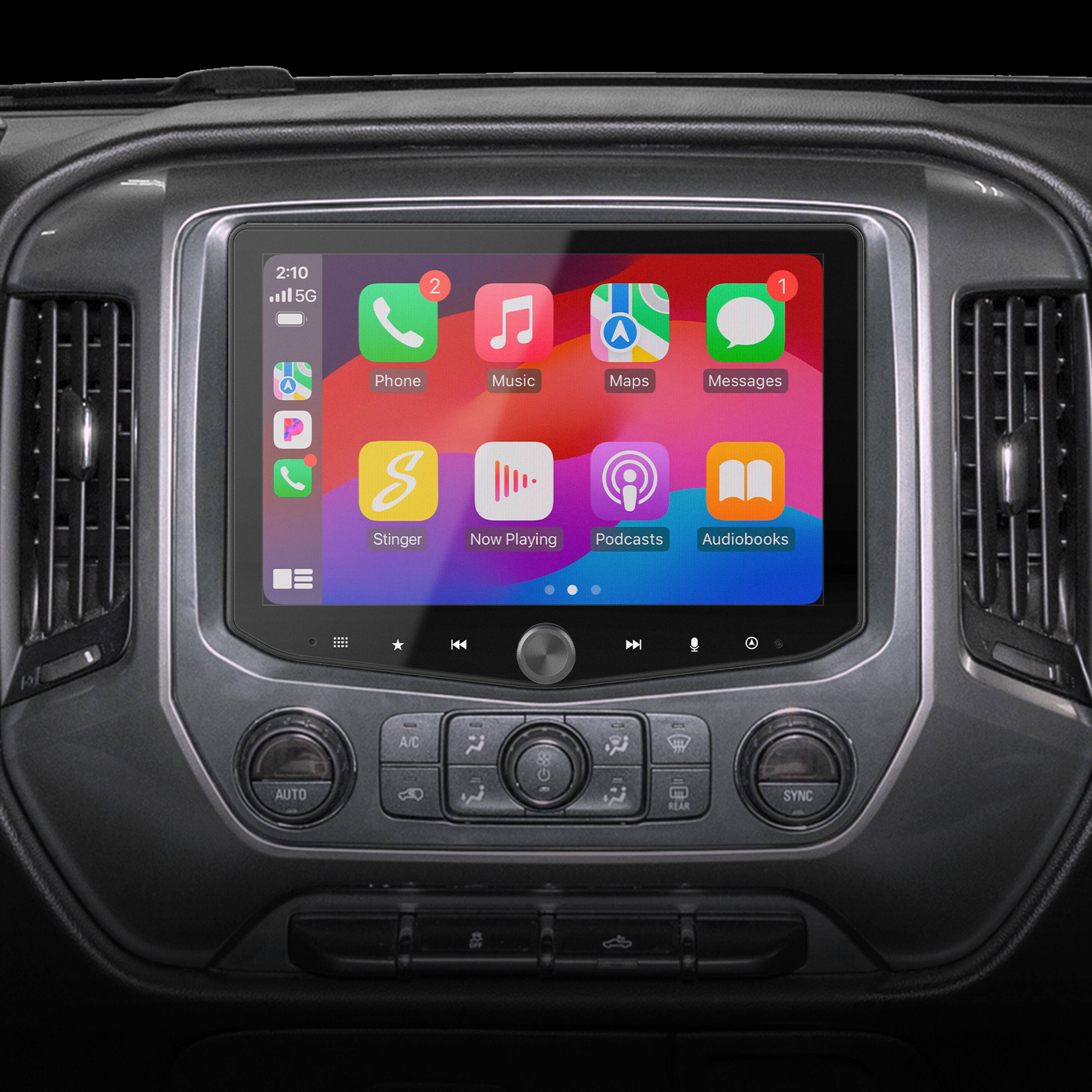 The text on the image reads: "2:10 .l 5G 2 1 Phone Music Maps Messages S Stinger Now Playing 8 Podcasts Audiobooks * 44 D l A/C JIL AUTO REAR SYNC."