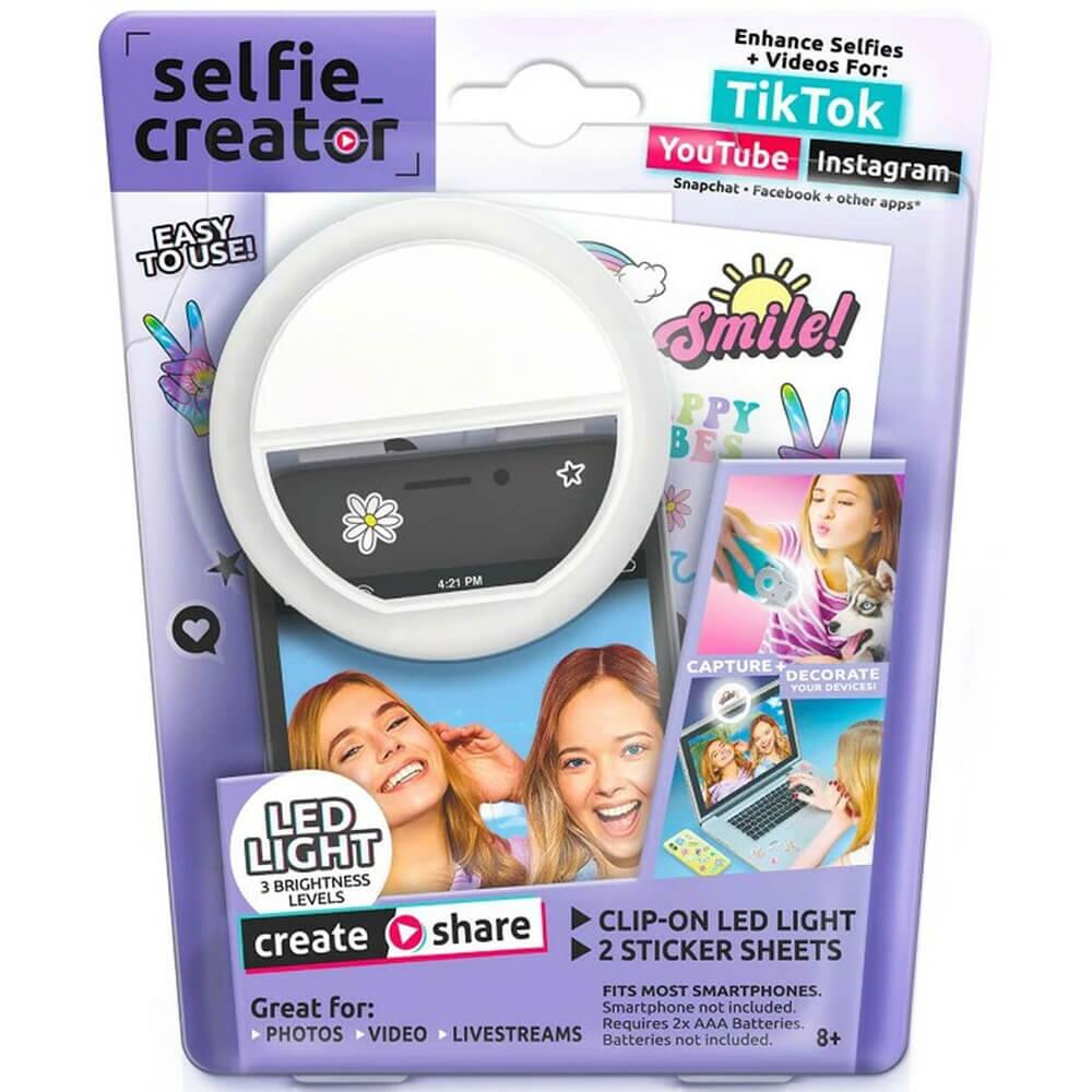 selfie creator EASY TO USE! TO Enhance Selfies + Videos For: TikTok YouTube Instagram Snapchat Facebook + other apps* Smile! PPY BES 4:21 PM

CAPTURE DECORATE YOUR DEVICES! LED LIGHT 3 BRIGHTNESS LEVELS share CLIP-ON LED LIGHT create 2 STICKER SHEETS FITS MOST SMARTPHONES. Great for: Smartphone not included. Requires 2x AAA Batteries. PHOTOS VIDEO LIVESTREAMS Batteries not included. 8+