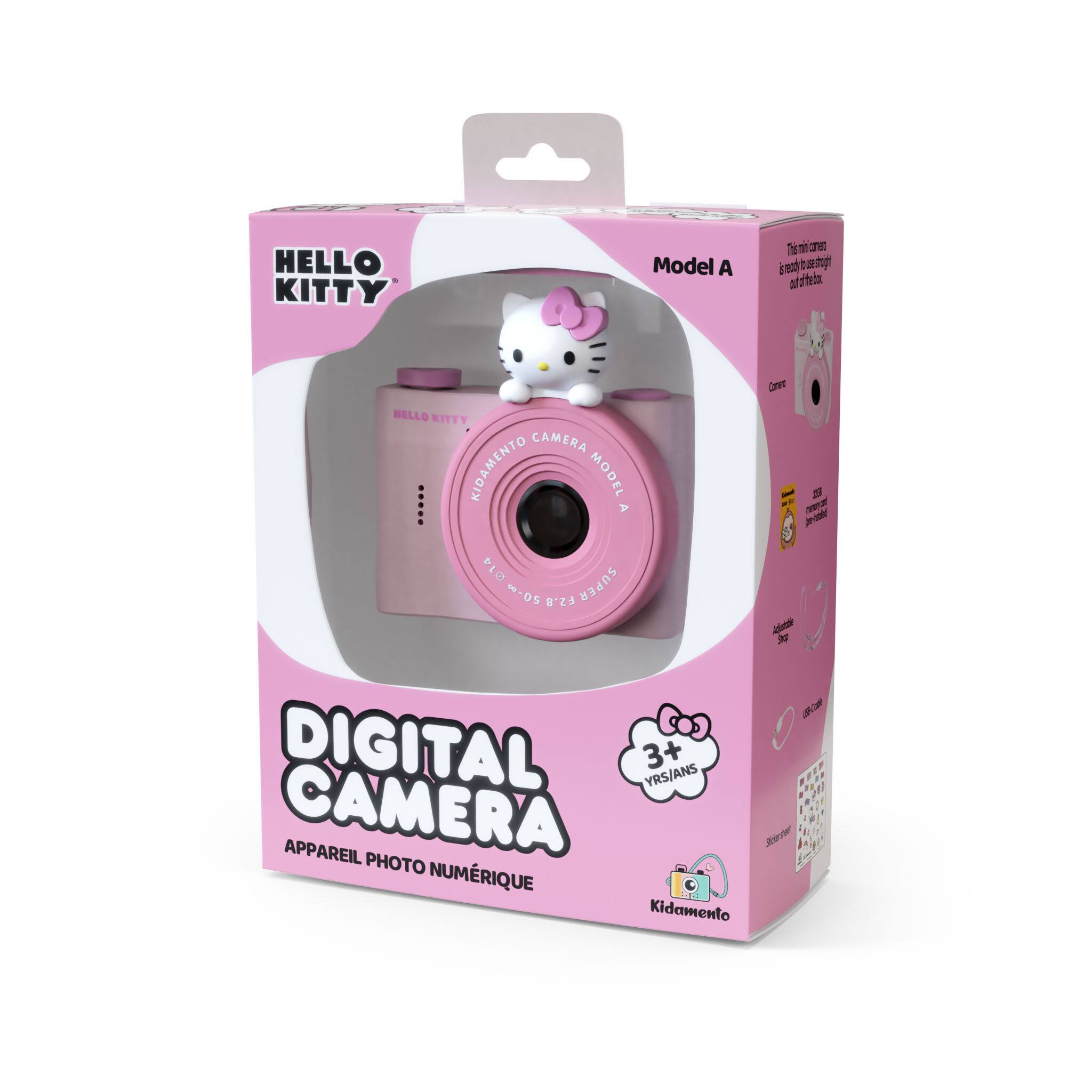 The text on the image reads: "Hello Kitty Camera Model A 0514 ~-05 F2.8 Super Dneo - 2  NeZ p - J 2 Digital 3+ YRS/ANS CAMERA APPAREIL PHOTO + F NUMRIQUE Kidamento."