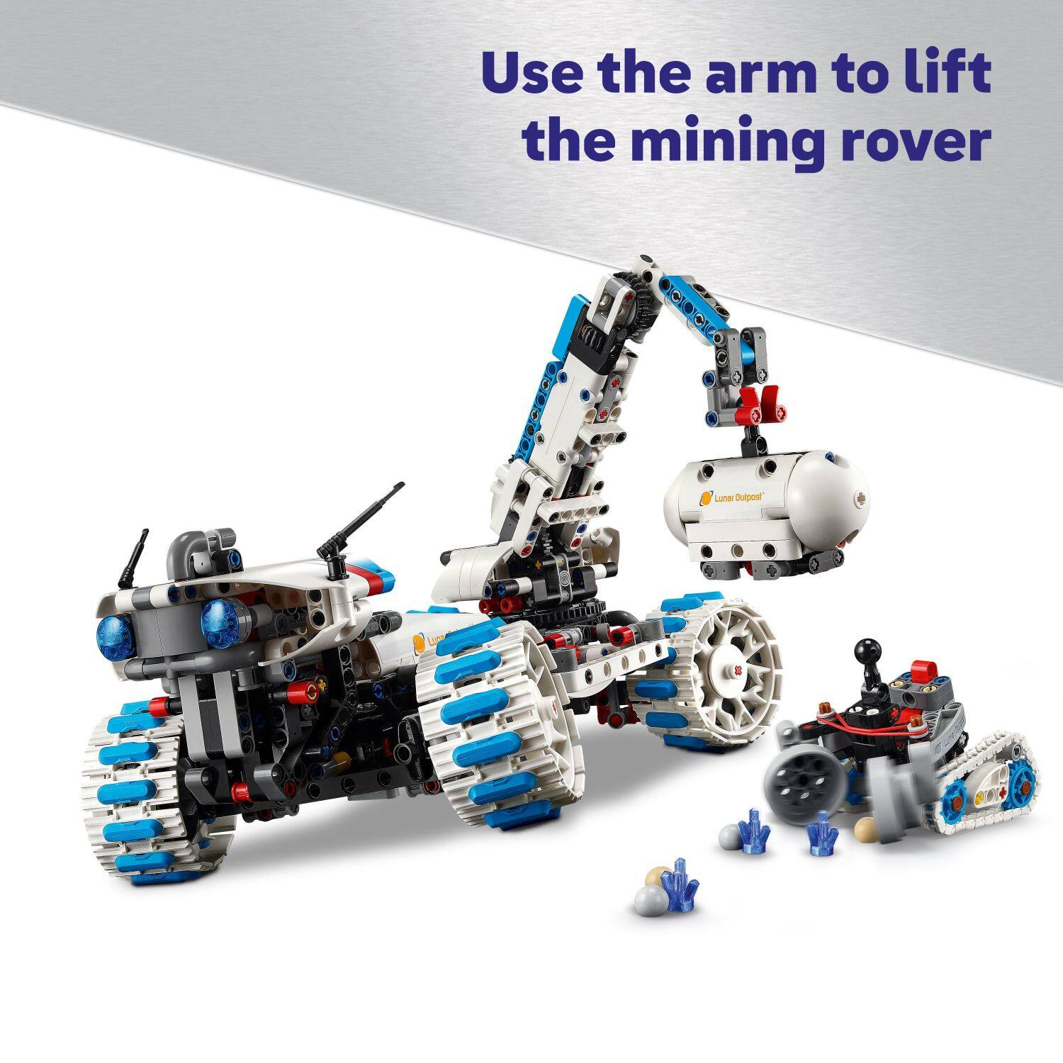 Use the arm to lift the mining rover. Lune Oulpent.
