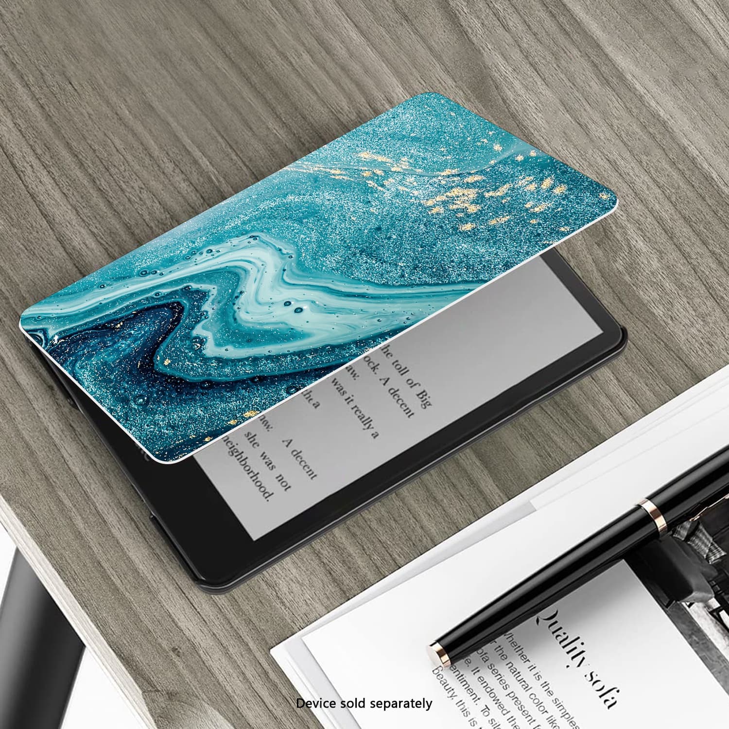 The image shows a cell phone with a blue case on top of a book. The phone is open, displaying a book cover. The case has a blue and gold design, and the phone is placed on a wooden table. The text on the image reads "Quality is Beauty," which suggests that the phone case and the book are of high quality. The phone is not attached to a wall, and the device is sold separately. The image also features a pen on the table, possibly for taking notes or highlighting important information in the book.