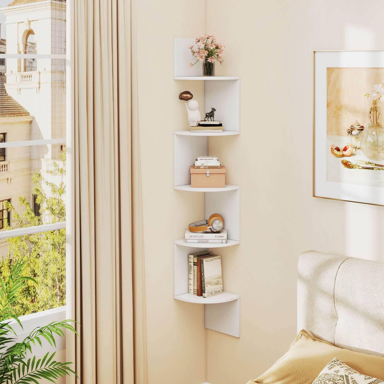 A white bookshelf is filled with books, a vase, and a football. The bookshelf is located in a room with a window, and there is a bed in the room as well. The books are arranged on the shelves, and the vase is placed on top of the bookshelf. The football is also displayed on the bookshelf, adding a unique touch to the room's decor.