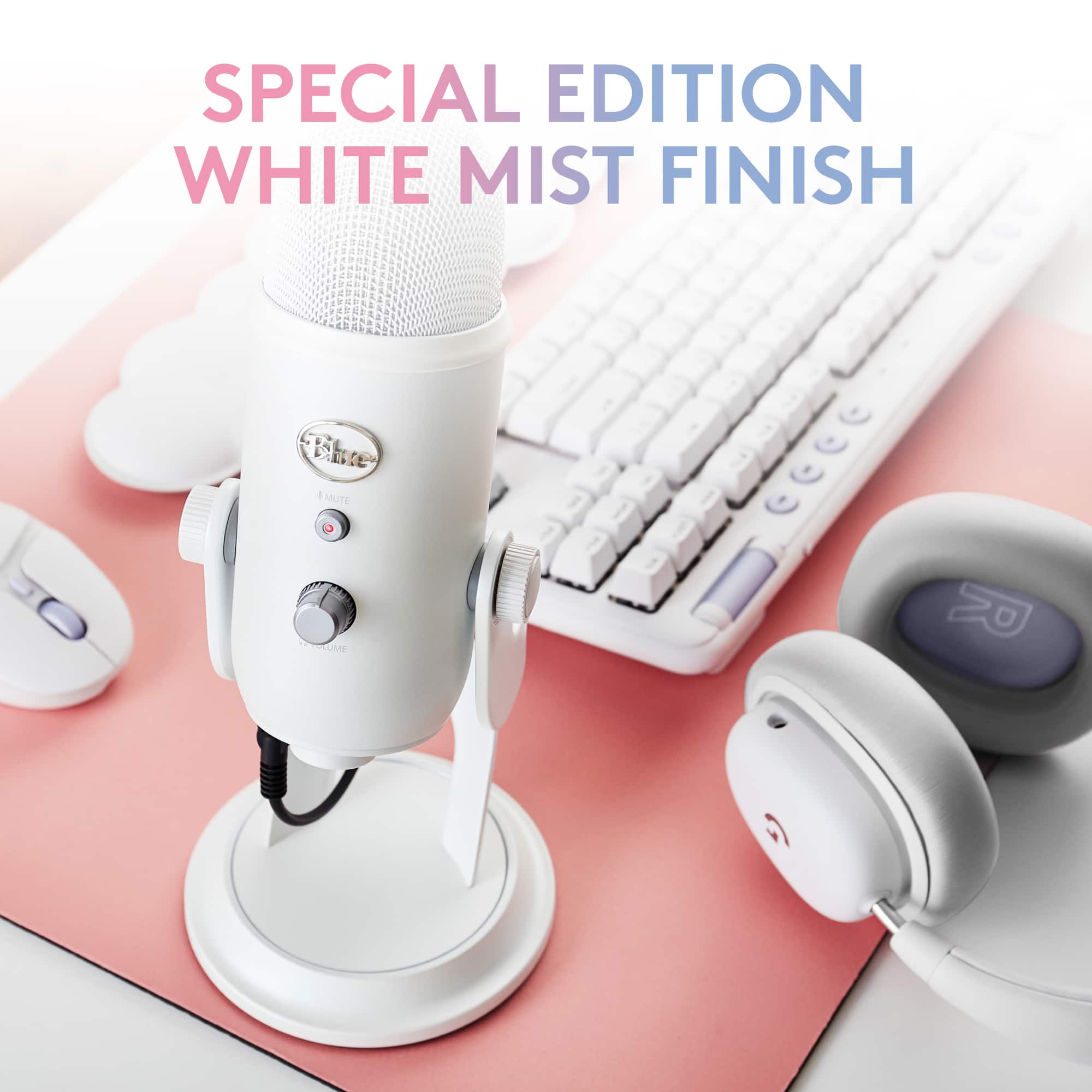 The image features a special edition white mist finish microphone, which is placed on a pink table. The microphone is accompanied by a keyboard and a mouse, creating a complete setup for recording or streaming purposes.