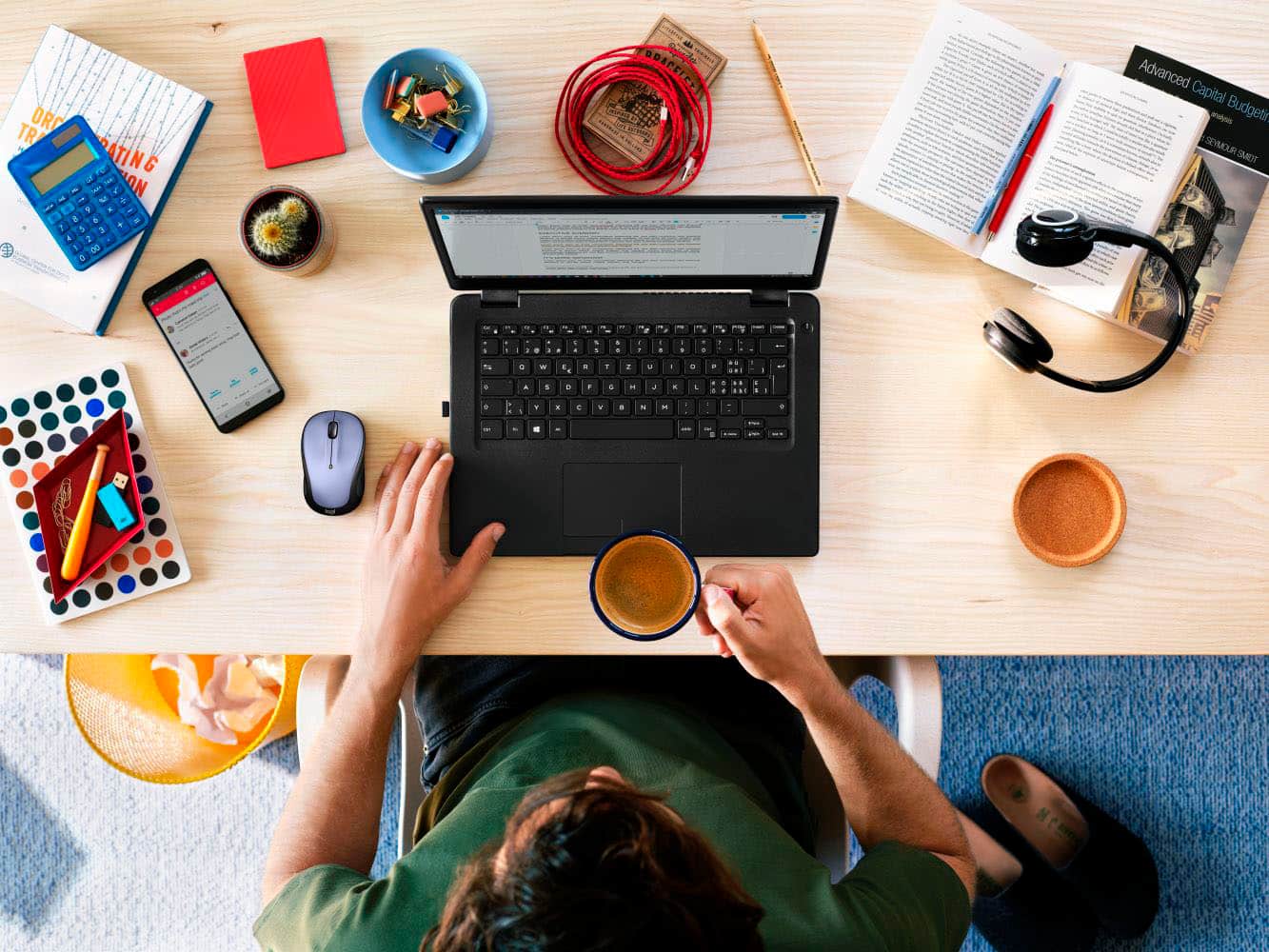The text on the image is a jumble of words, making it difficult to group and correct. However, I can provide a general explanation of what the image depicts.
The image features a person sitting at a desk, working on a laptop computer. The desk is cluttered with various items, including books, a cell phone, a mouse, and a cup. The person appears to be focused on their work, possibly using the laptop for tasks such as writing, researching, or communicating with others. The presence of multiple books and the cluttered desk suggest that the person might be engaged in a complex project or working in a busy environment.