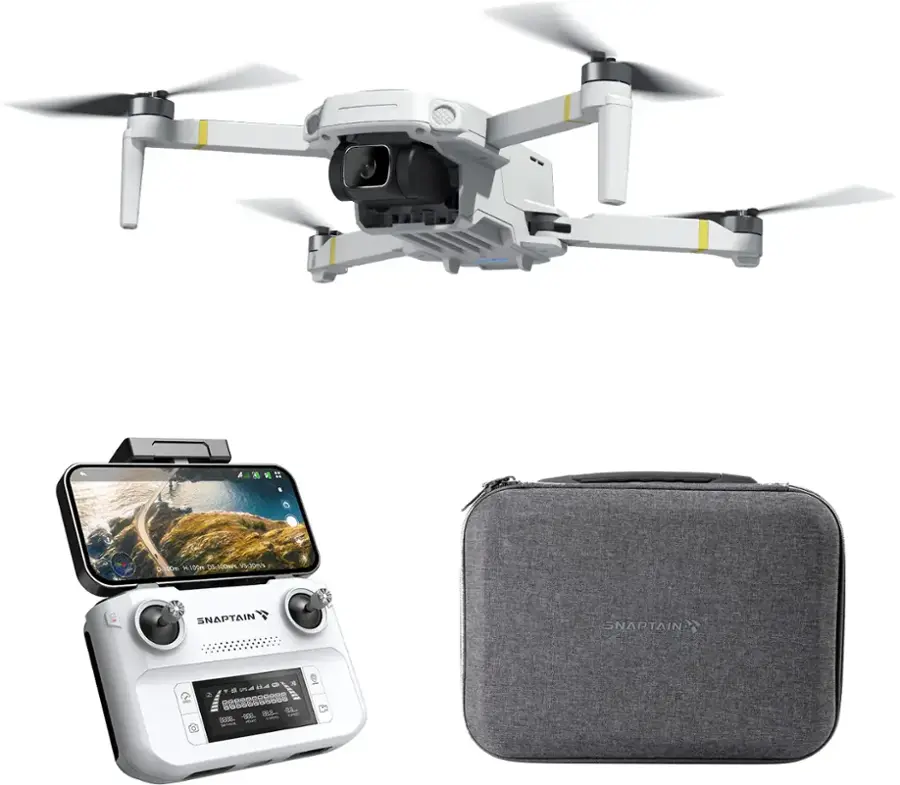 The image features a drone, a cell phone, and a case. The drone is a white quadcopter with a camera attached to it. The cell phone is placed next to the drone, and the case is located below the drone. The drone is likely being used for aerial photography or videography, as it is equipped with a camera. The cell phone may be used for controlling the drone or for capturing images and videos from the ground. The case could be used for storing the drone or other related equipment.