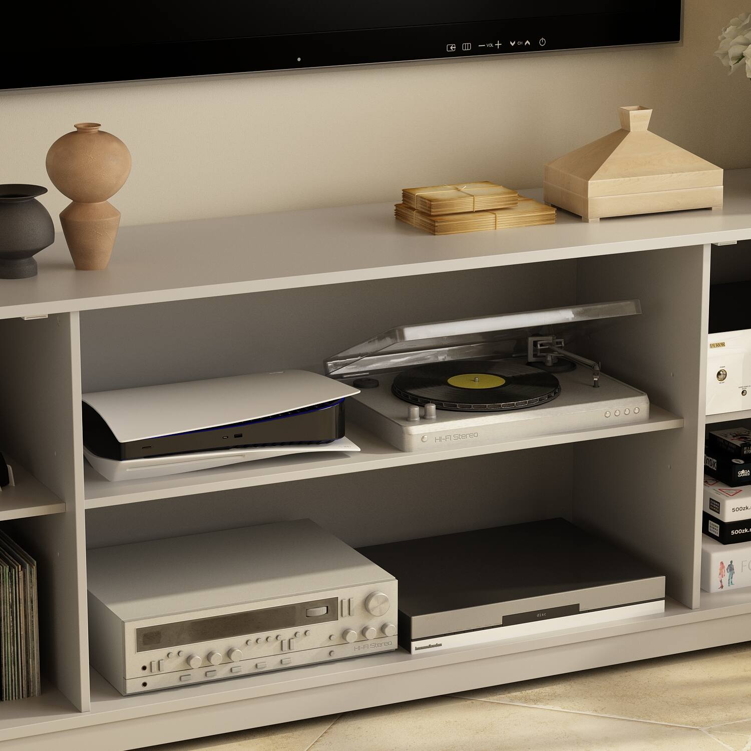 The image shows a shelf with various items on it, including a record player, a vase, and a stack of records. The record player is placed on the left side of the shelf, while the vase is located on the right side. The stack of records is placed in the middle of the shelf. The shelf is situated in front of a television, creating a cozy entertainment area.