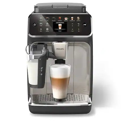The image features a black and silver coffee maker with a beverage in it. The beverage appears to be a frothy, foamy drink, possibly a latte or a macchiato. The coffee maker is made by Philips, as indicated by the brand name displayed on the machine.
