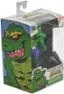 The image features a green Teenage Mutant Ninja Turtles action figure in its original packaging. The figure is a mutant alligator character named Leatherhead. The packaging is a clear plastic case, and the figure is sitting inside the case. The back of the packaging displays the name "Leatherhead" and the brand "Neca."