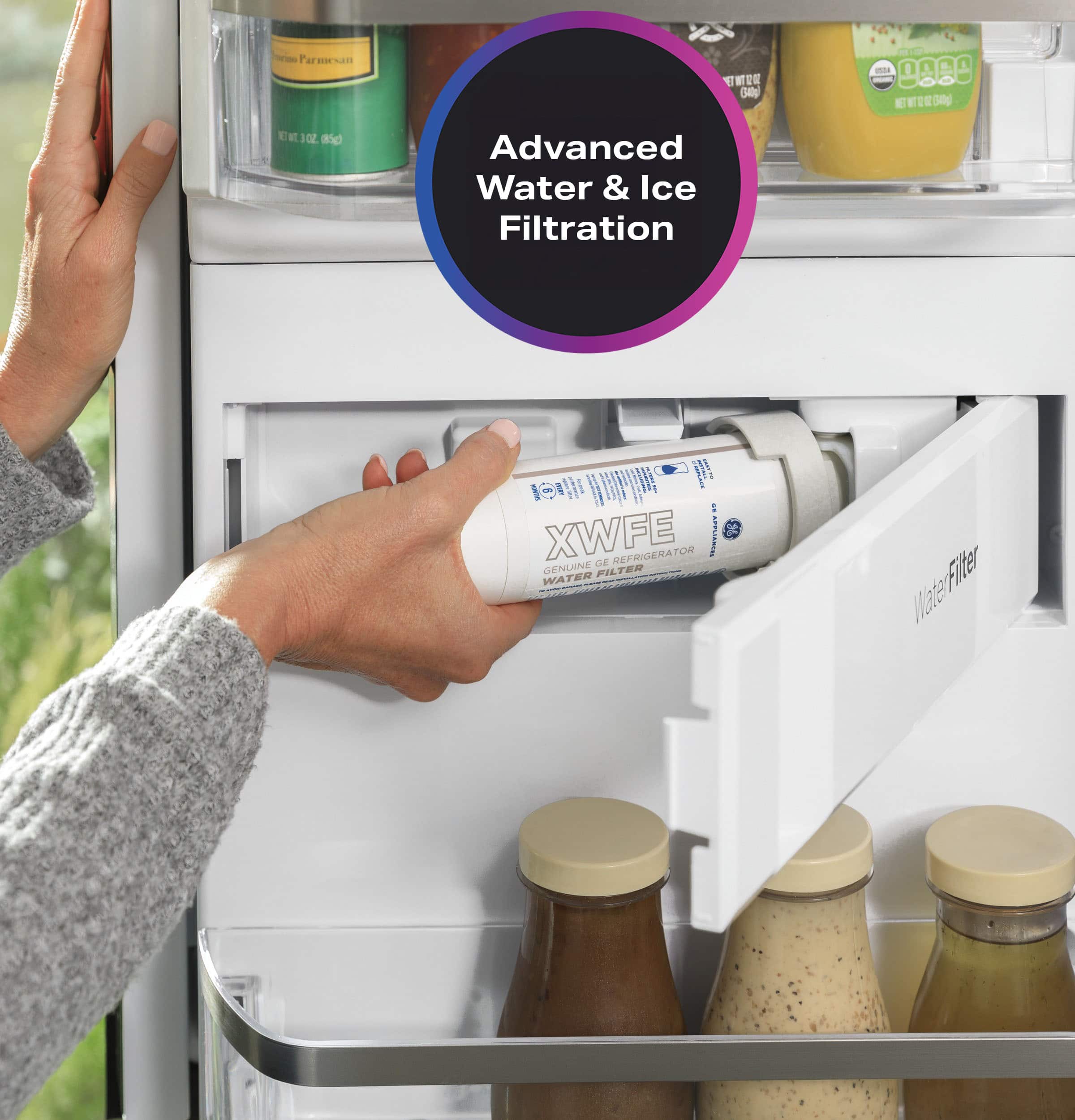 The text on the image is about advanced water and ice filtration. It is promoting a genuine filter water system that is designed to remove impurities and contaminants from the water and ice in a refrigerator. The filter is placed in the refrigerator door, and the person is holding it out of the refrigerator. The text emphasizes the benefits of using this filtration system, such as improved taste and quality of the water and ice, and the removal of harmful contaminants.
