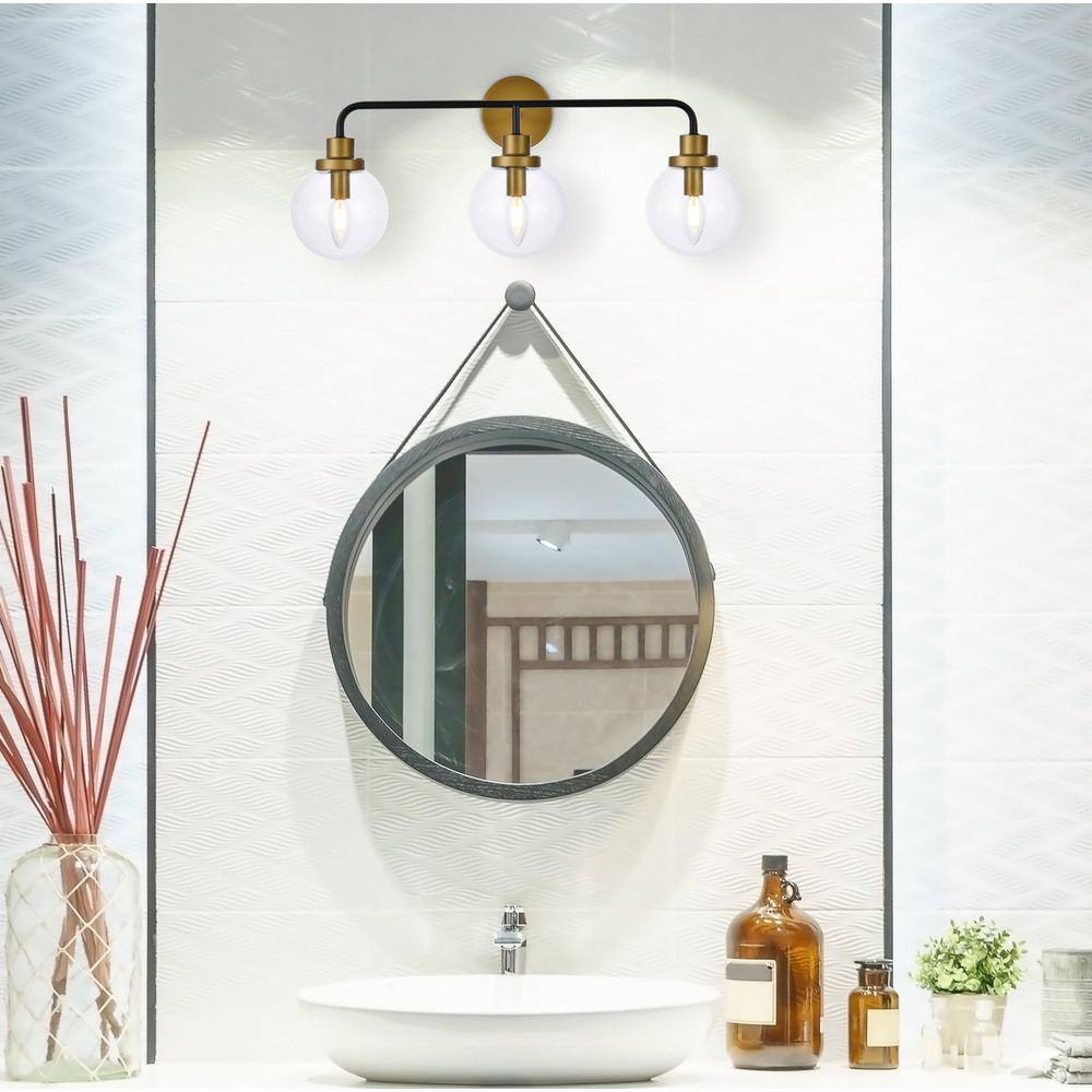 Angle. Living District - Hanson 3 lights bath sconce in black with brass with clear shade - Black And Brass And Clear Shade.