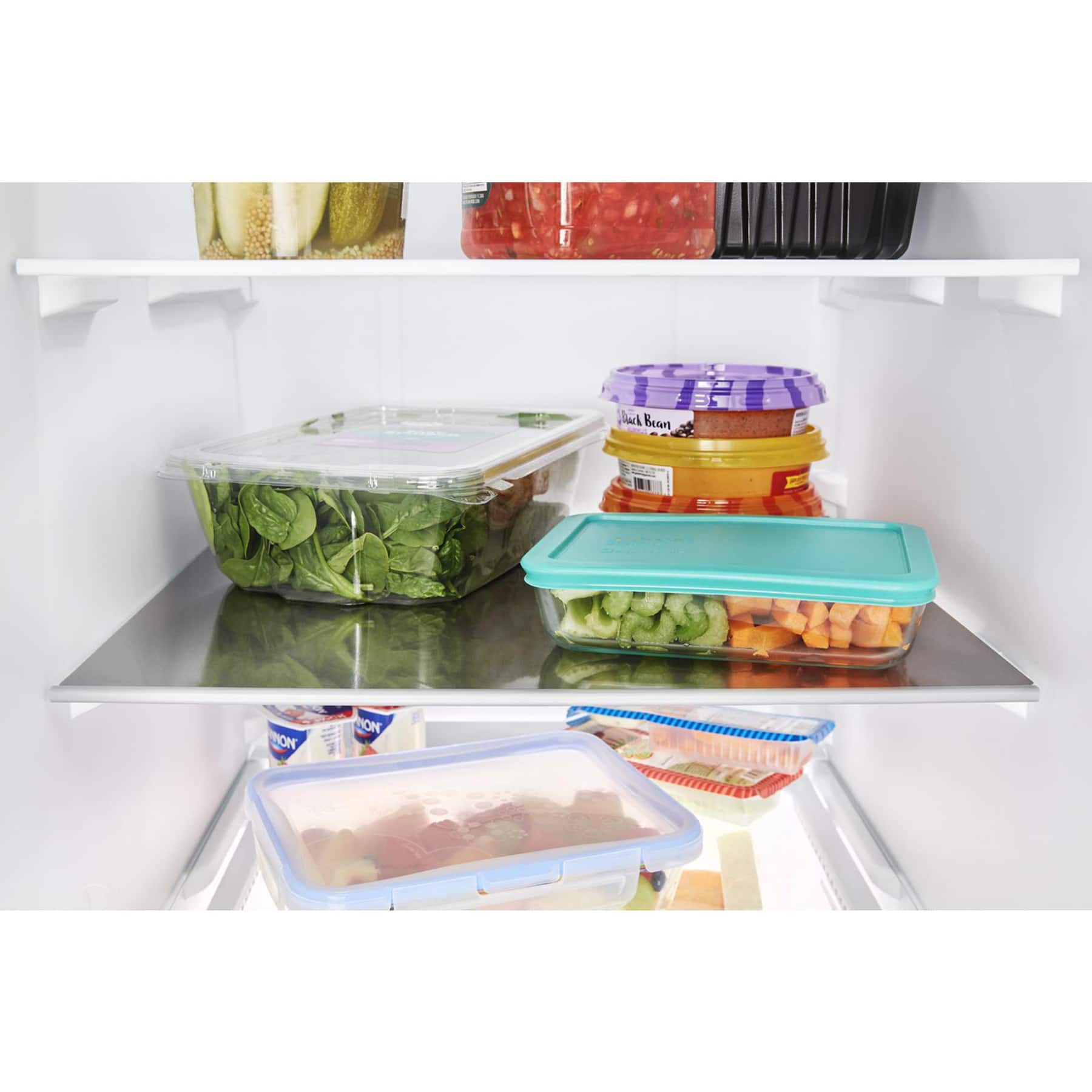 The image shows a refrigerator with several food items stored in it. There are multiple containers, including a container of green beans, a container of carrots, and a container of broccoli. The refrigerator is filled with a variety of foods, making it a well-stocked and organized space for storing fresh produce.