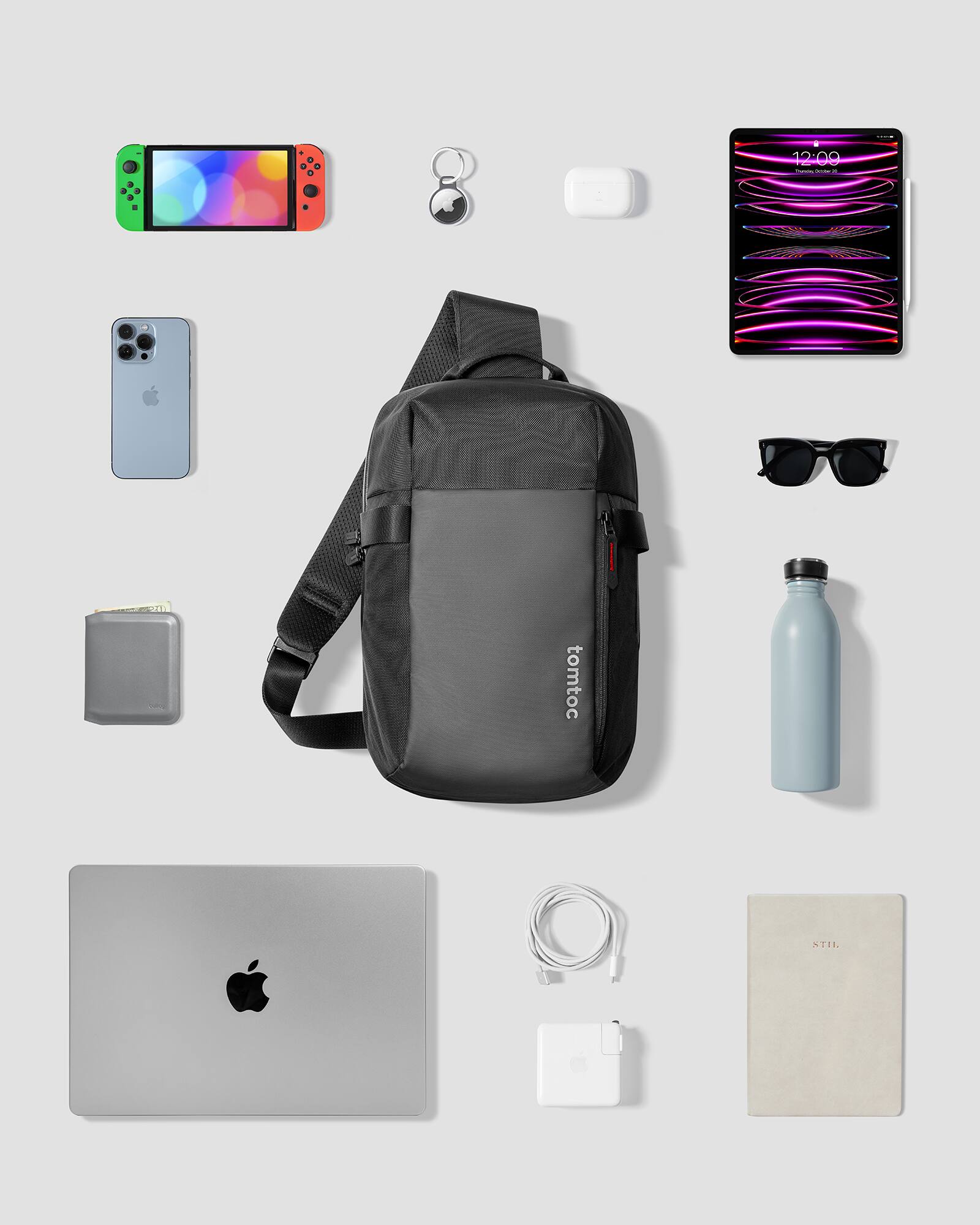 The image features a variety of items, including a backpack, laptop, cell phone, sunglasses, and a bottle. The backpack is placed in the center of the image, while the laptop is located on the left side. The cell phone is positioned towards the top left corner, and the sunglasses are situated on the right side of the image. The bottle is placed in the lower right corner. The arrangement of these items suggests that they are part of a traveler's belongings, possibly for a trip or outdoor adventure.