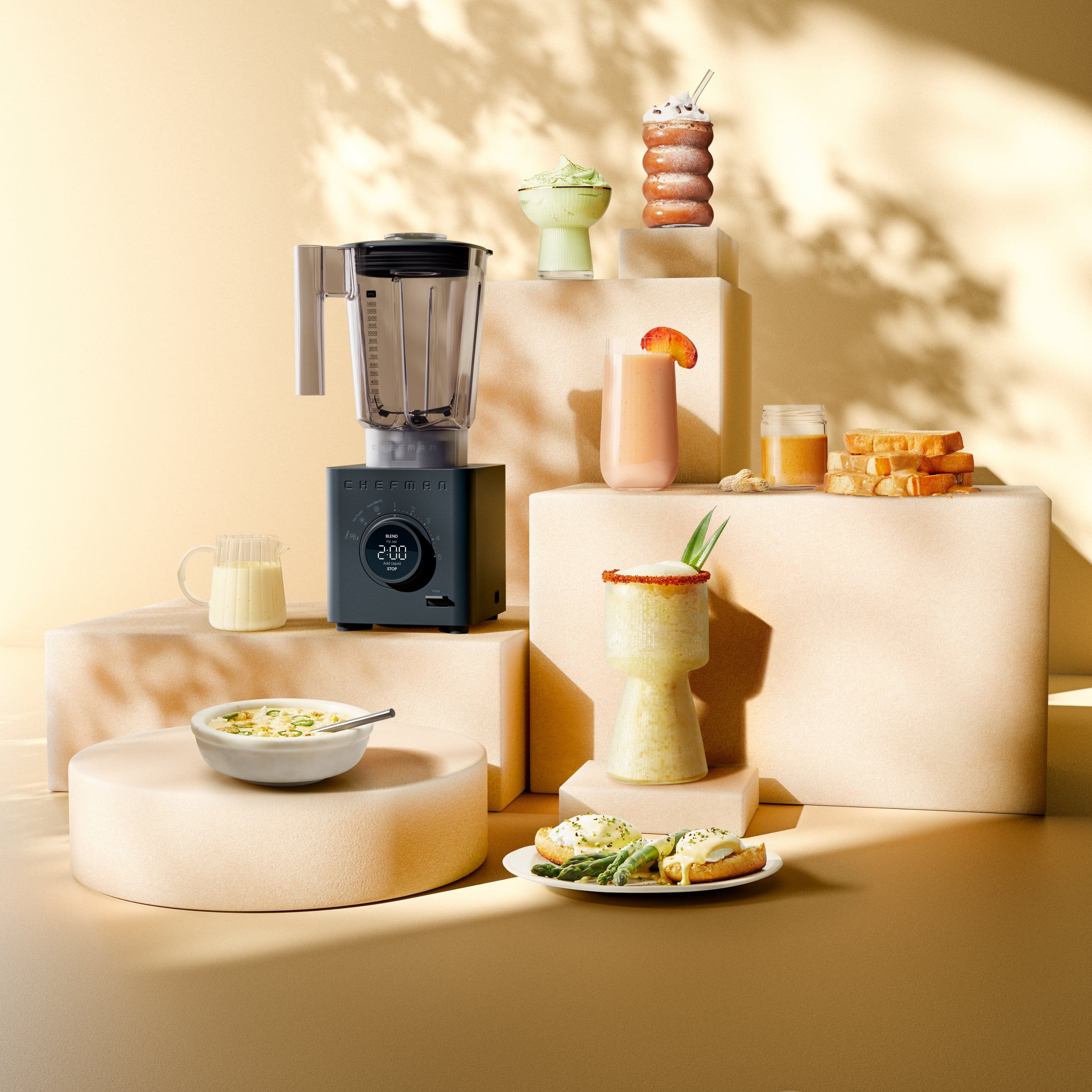 The image features a variety of food and drink items arranged on a dining table. There are several bowls containing different types of food, including a bowl of soup, a bowl of fruit, and a bowl of cookies. There are also multiple cups and a wine glass, as well as a bottle and a vase. A blender is also present on the table, indicating that it might have been used to prepare some of the food or drinks. The table is set up in a way that encourages a pleasant dining experience, with the various items neatly arranged and ready to be enjoyed.