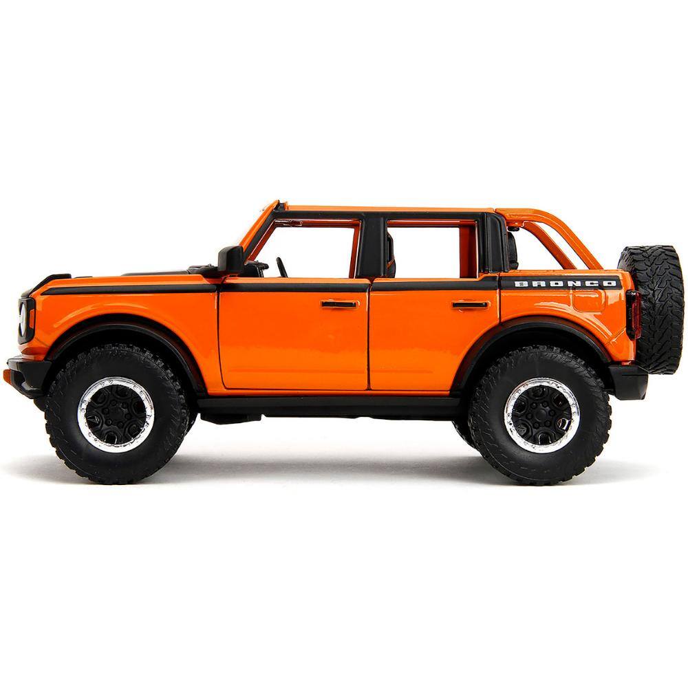 Left. Jada - 2021 Ford Bronco Open-Top Orange with Black Stripes and Hood with Extra Wheels "Just Trucks" Series 1/24 - Orange with Black Stripes.
