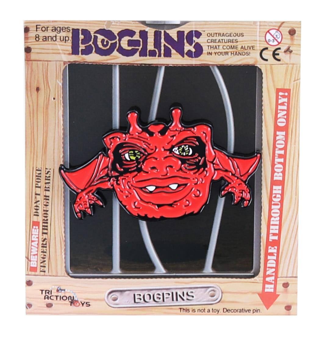 For ages 8 and up  
BOGINS  
OUTRAGEOUS CREATURES THAT COME ALIVE IN YOUR HANDS!  

BEWARE: FINGERS THROUGH FINGERS!  
HANDLE THROUGH BOTTOM ONLY!  

This is not a toy. Decorative pin.  

TRI ACTION TOYS