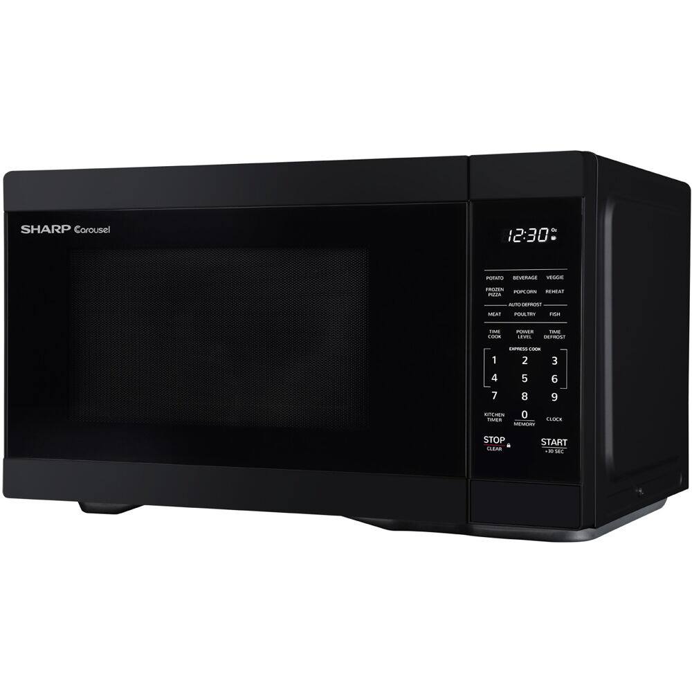 The image shows a black Sharp microwave oven with a digital clock on the front. The clock displays the time as 12:30. The microwave is sitting on a counter, and it appears to be a compact model.