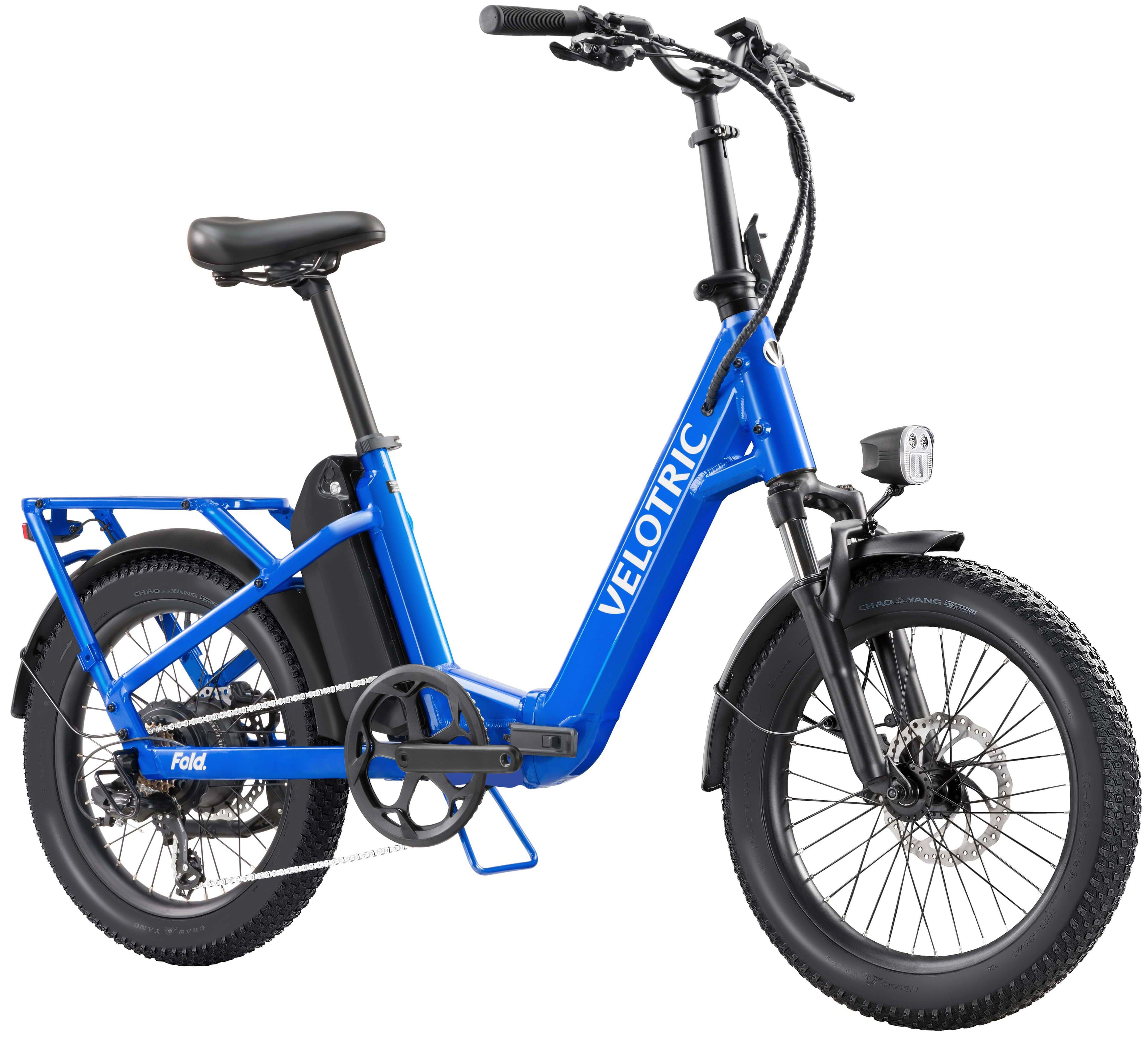 Velotric is a brand of bicycles, and the image shows a blue one with a black seat. The bike has a foldable design, making it convenient for transportation and storage.
