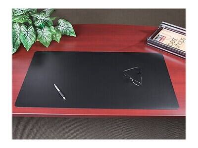 The image does not contain any text. It shows a desk with a black mouse pad, a pen, a paper clip, a plant, and a stapler.