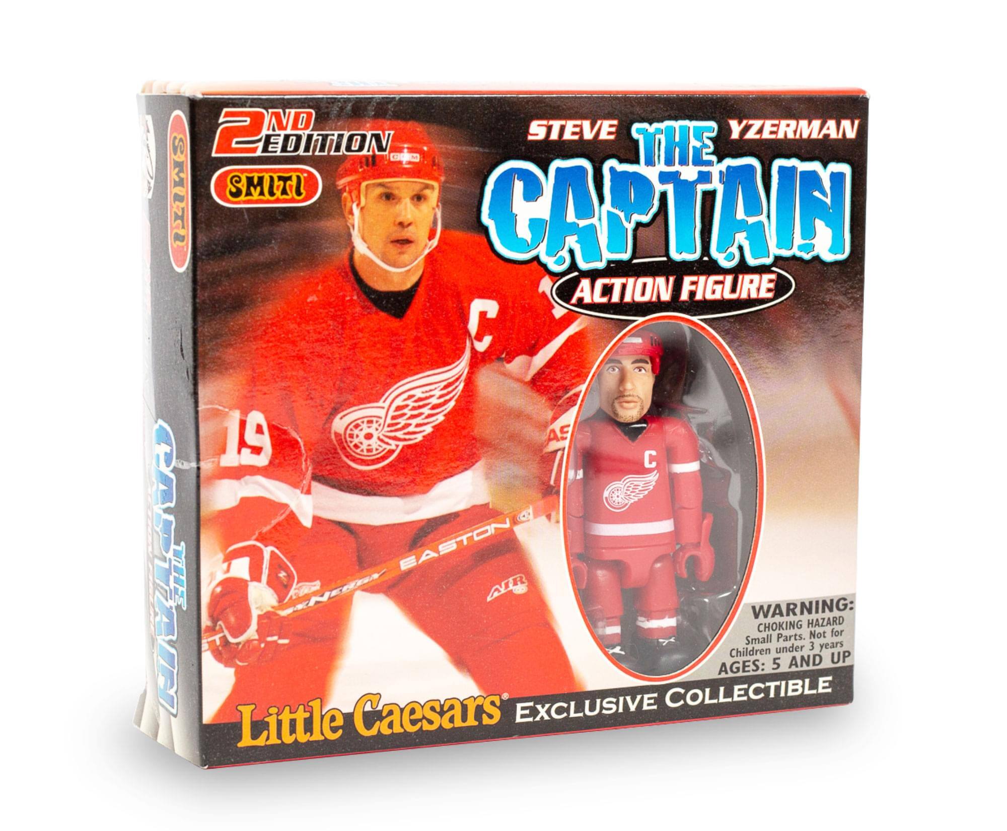 Sure, here is the corrected and grouped text from the image:

---

**2nd Edition**

**Steve Yzerman**  
**The Captain**  
**Action Figure**

**Little Caesars**  
**Exclusive Collectible**

**Warning:**  
**Choking Hazard**  
Small Parts. Not for Children under 3 years  
**Ages: 5 and up**

**Smiti**

**C 19**

**EASTON**

---

This text is organized to reflect the information as it appears on the packaging.