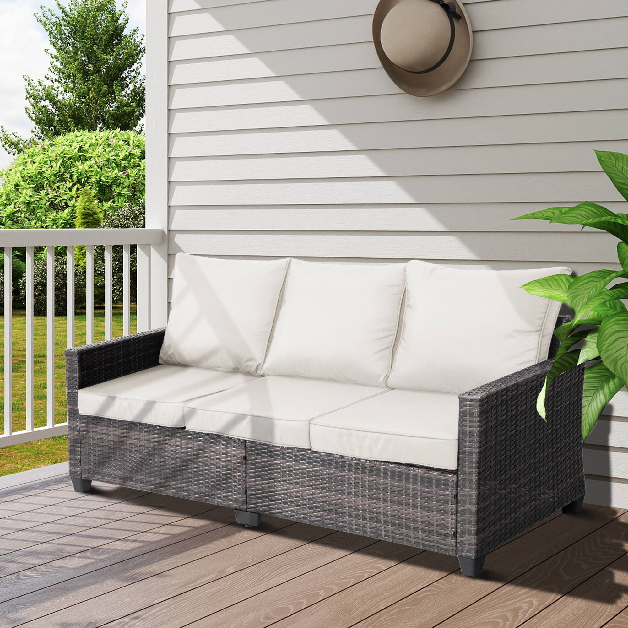 Angle. Decksplore - All-weather three-seater wicker patio sofa, premium outdoor furniture featuring brown wickerwork and thickened cushions - Off-white.