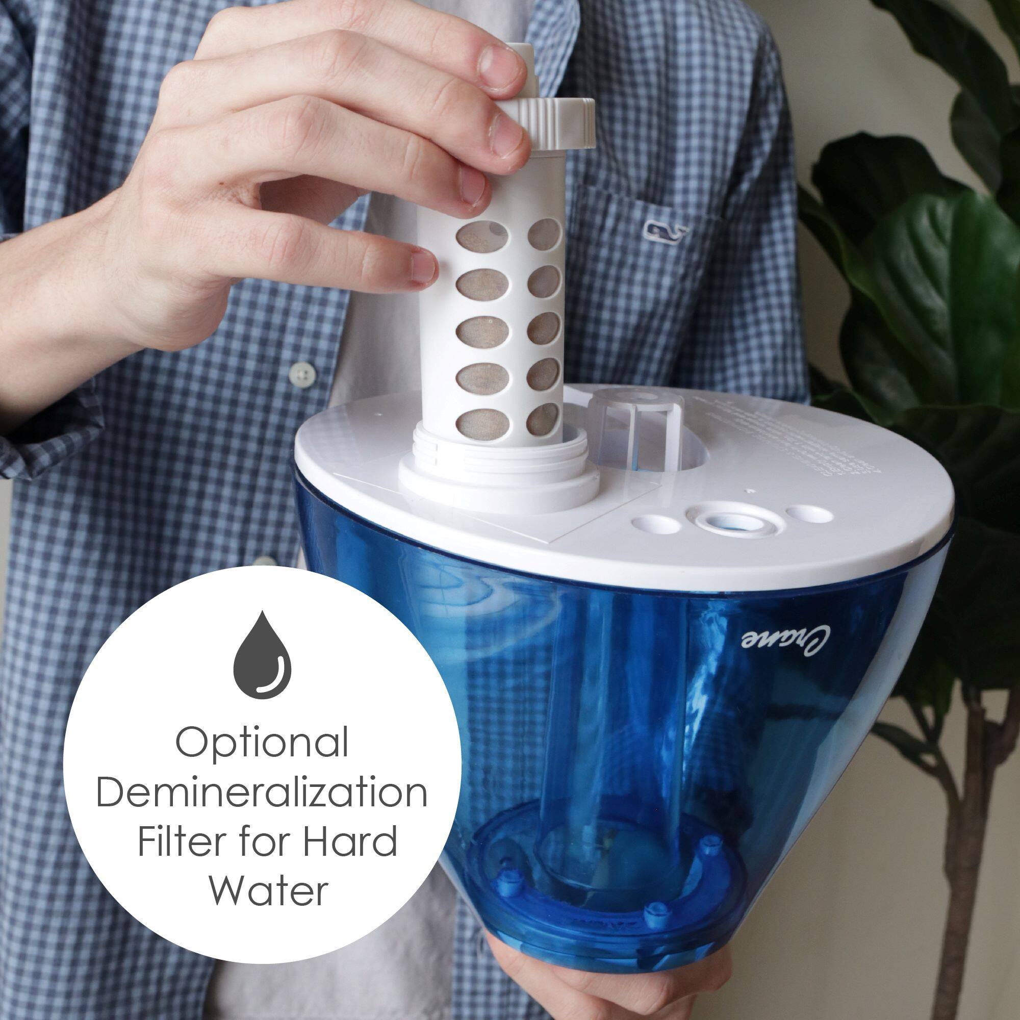 The image shows a person holding a blue water filter in their hands. The filter is designed to remove minerals from hard water, providing a cleaner and safer source of drinking water. The filter is easy to use and can be a convenient solution for those who want to improve the quality of their water.