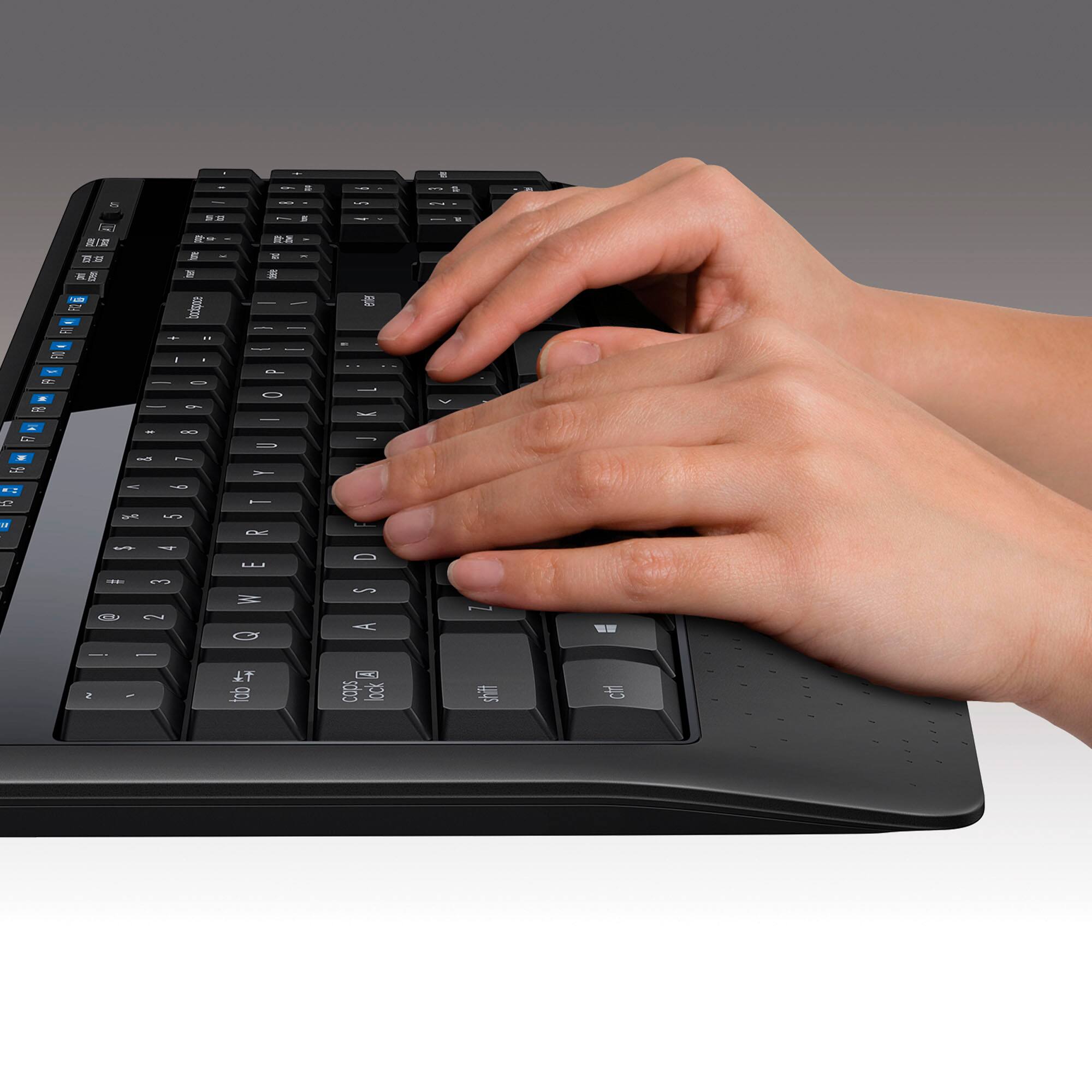 The text on the image is a keyboard layout, which includes various keys such as the space bar, shift, and other function keys. The layout is designed to facilitate typing and navigation on a computer. The image shows a person's hand using the keyboard, with their fingers pressing the keys.