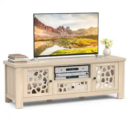 The image features a flat screen TV sitting on top of a wooden stand. The TV is turned on and displaying a beautiful mountain scene. The stand has a shelf underneath the TV, which is currently empty. There are also two books placed on the stand, one on the left side and the other on the right side. Additionally, there is a vase with flowers in it, adding a touch of decoration to the scene.