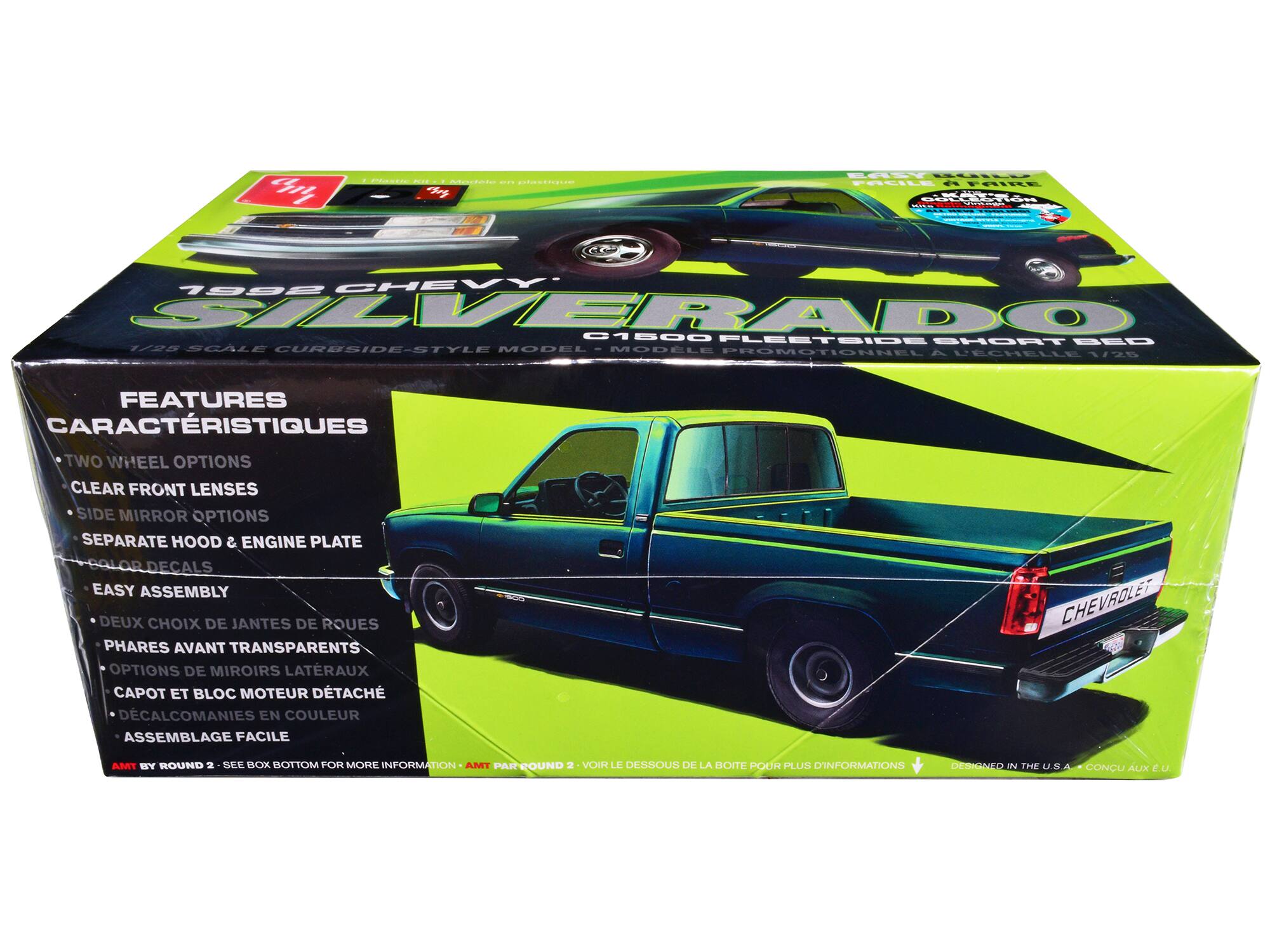 Sure, here is the corrected and grouped text from the image:

---

**1992 CHEVY SILVERADO**  
1/28 SCALE CURBSIDE-STYLE MODEL - MODÈLE PROMOTIONNEL À DEGHELLE

**FEATURES**  
- TWO WHEEL OPTIONS  
- CLEAR FRONT LENSES  
- SIDE MIRROR OPTIONS  
- SEPARATE HOOD & ENGINE PLATE  
- COLOR DECALS  
- EASY ASSEMBLY  

**CARACTÉRISTIQUES**  
- DEUX CHOIX DE JANTES DE ROUES  
- PHARES AVANT TRANSPARENTS  
- OPTIONS DE MIROIRS LATÉRAUX  
- CAPOT ET BLOC MOTEUR DÉTACHÉ  
- DÉCALCOMANIES EN COULEUR  
- ASSEMBLAGE FACILE  

**EASY TO BUILD**  
**FACILE À ASSEMBLER**  

**AMT BY ROUND 2 - SEE BOX BOTTOM FOR MORE INFORMATION**  
**AMT PAR ROUND 2 - VOIR LE DESSOUS DE LA BOÎTE POUR PLUS D'INFORMATIONS**

**DESIGNED IN THE U.S.A.**  
**CONÇU AUX É