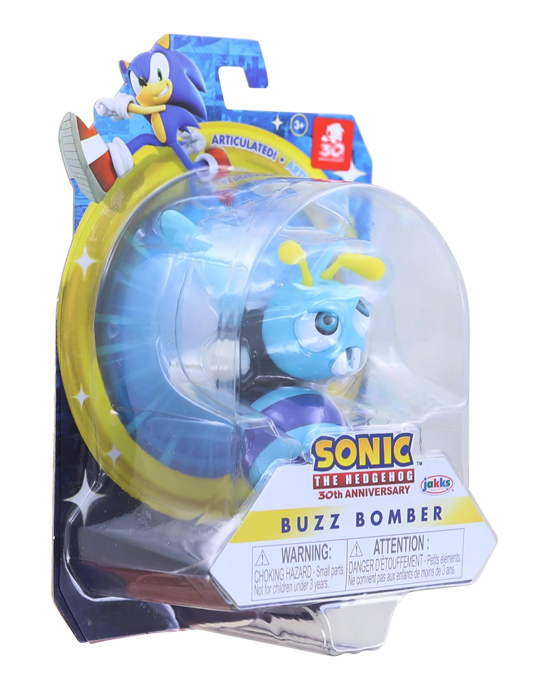 Sure, here is the corrected and grouped text from the image:

---

**SONIC THE HEDGEHOG**  
30th ANNIVERSARY  
BUZZ BOMBER  

**ARTICULATED**  

**WARNING:**  
CHOKING HAZARD - Small parts.  
Not for children under 3 years.  

**ATTENTION:**  
DANGER D'ÉTOUFFEMENT - Petits éléments.  
Ne convient pas aux enfants de moins de 3 ans.  

**jakks**  

---

This text is organized to reflect the information on the packaging.