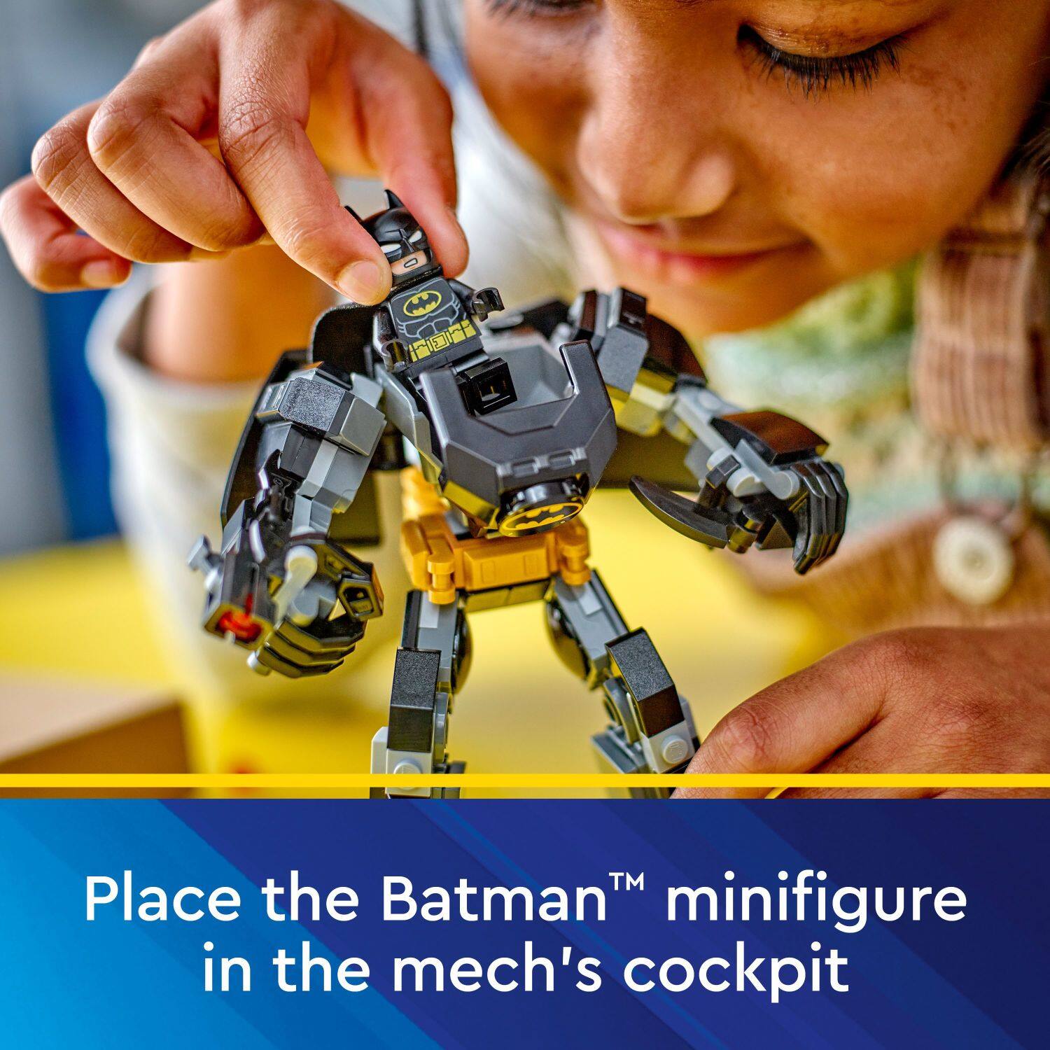 Place the BatmanTM minifigure in the mech's cockpit.
