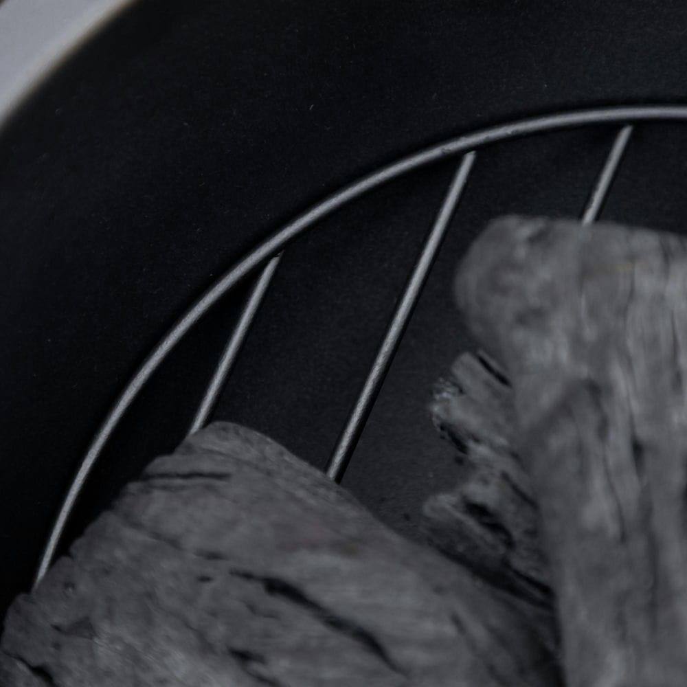 Angle. Resenkos - 24 Inch Outdoor Fire Pit, Metal Wood Burning Fireplace with Spark Cover, Poker for Patio, Picnic, Backyard, Light Brown.