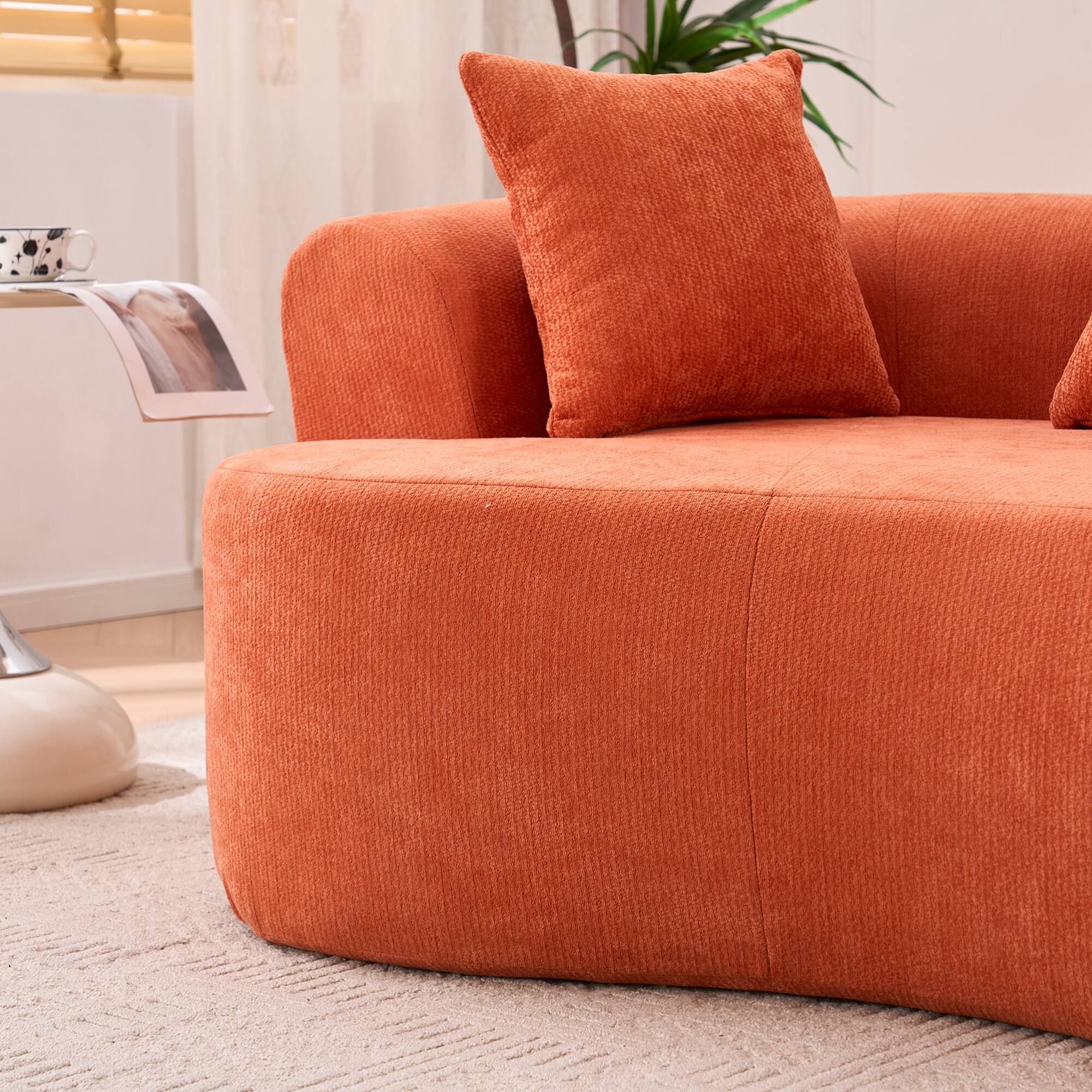 Left. GOODSILO - Modern Crescent-Shaped Sofa with Deep Cushions and Self-Inflating Foam, Three-Seater Design for Ultimate Comfort - Orange.