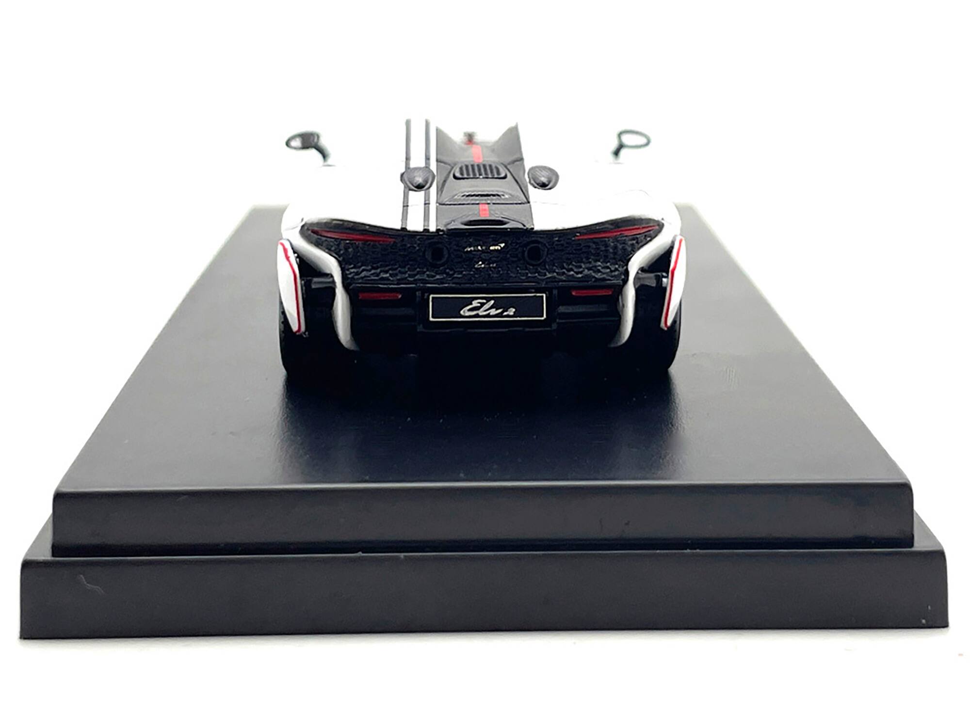 Left. LCD Models - McLaren Elva Convertible White with Carbon and Red Stripes 1/64 Diecast Model Car by LCD Models - White with Carbon and Red.