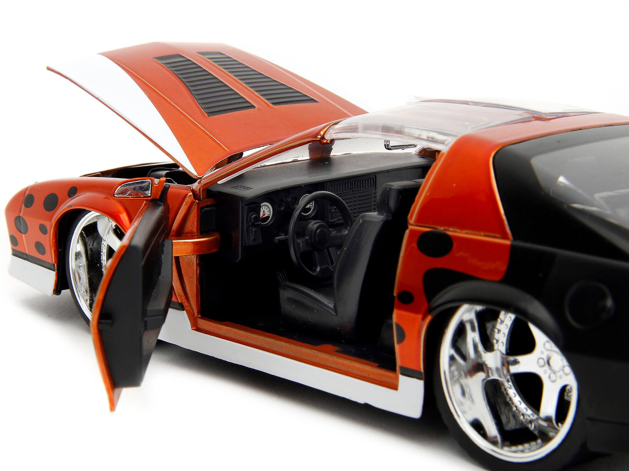 Left. Jada - 1985 Chevrolet Camaro Z/28 1/24 Diecast Orange Metallic with Graphics & Chester Cheetah Figure "Cheetos" Series - Orange Metallic.