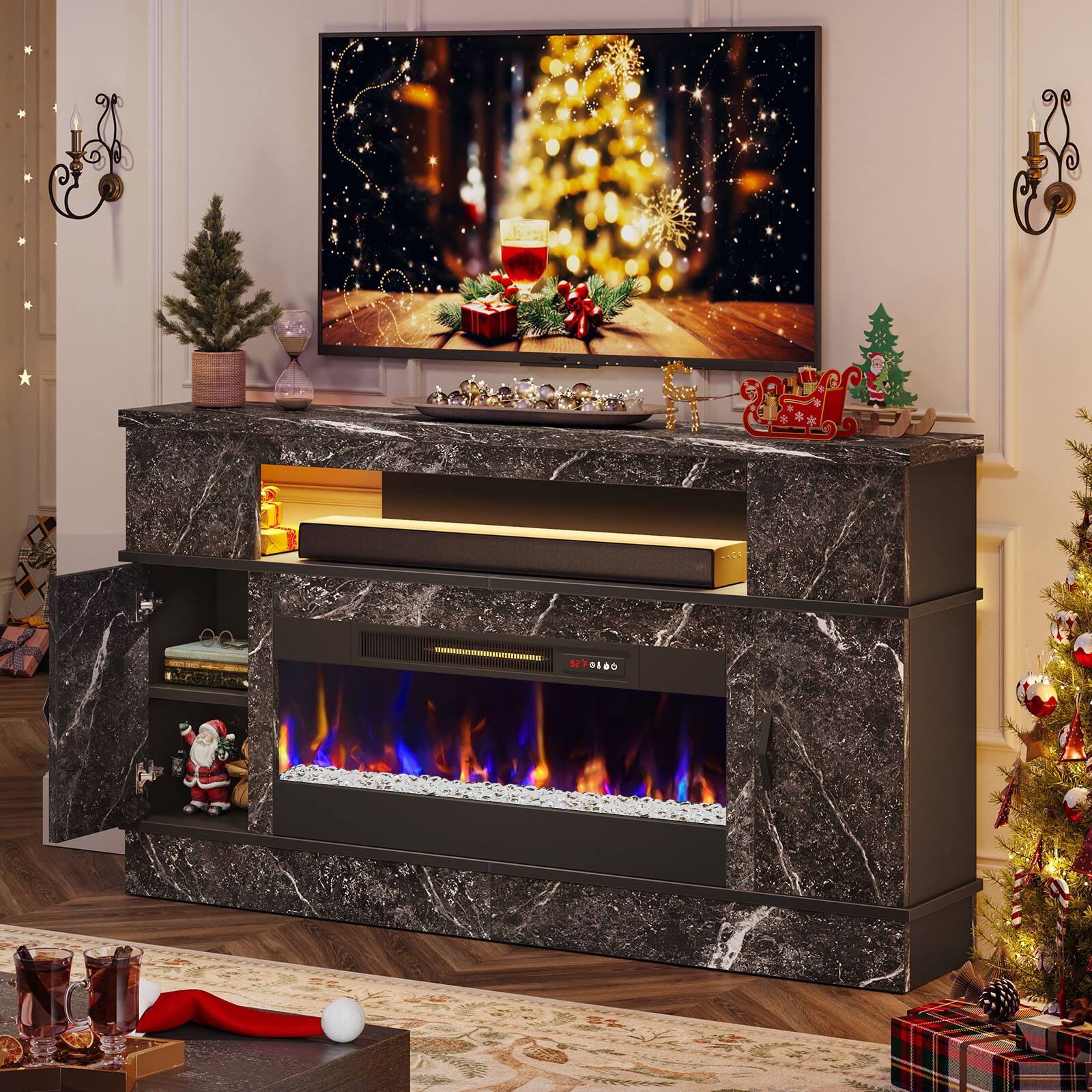 The image features a Christmas-themed room with a fireplace and a flat screen TV. The fireplace is lit, creating a warm and cozy atmosphere. The room also has a Christmas tree and a Santa Claus figurine, adding to the festive ambiance. The flat screen TV is placed on a countertop, making it a central focal point in the room. The combination of the fireplace, TV, and Christmas decorations creates a comfortable and inviting space for the holiday season.