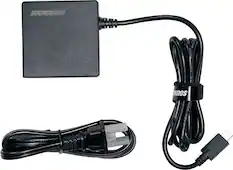 SOUNDBOKS is the brand name of the device in the image. The device is a black box with a cord attached to it. The cord is black and has a USB connector at the end. The device is designed to enhance sound quality, possibly for a computer or other electronic device.