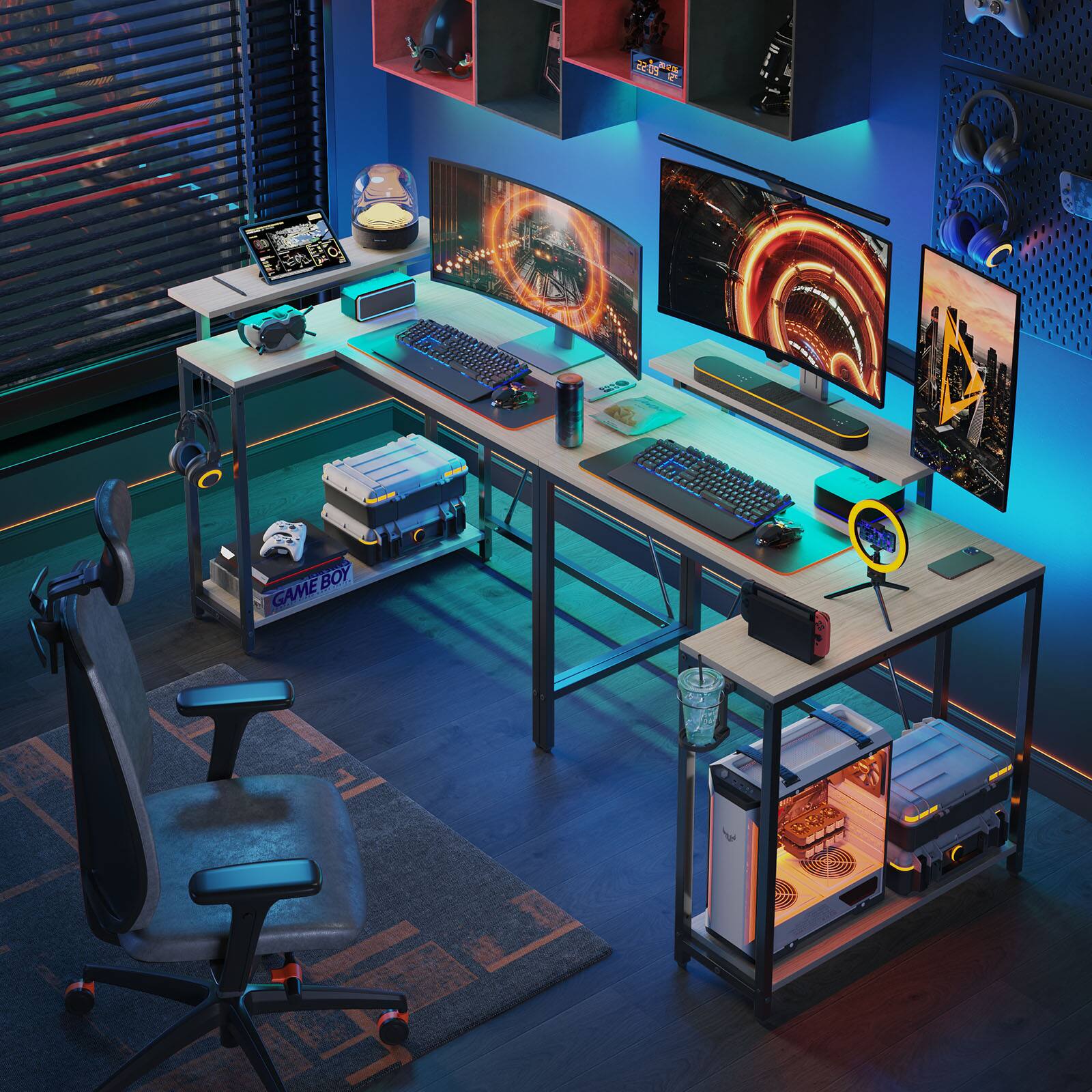 The image features a computer desk with a keyboard and a mouse on it. There are also two laptops on the desk, one on the left side and another on the right side. A chair is positioned in front of the desk, and a cup is placed on the desk. The room is dimly lit, creating a cozy atmosphere for gaming.