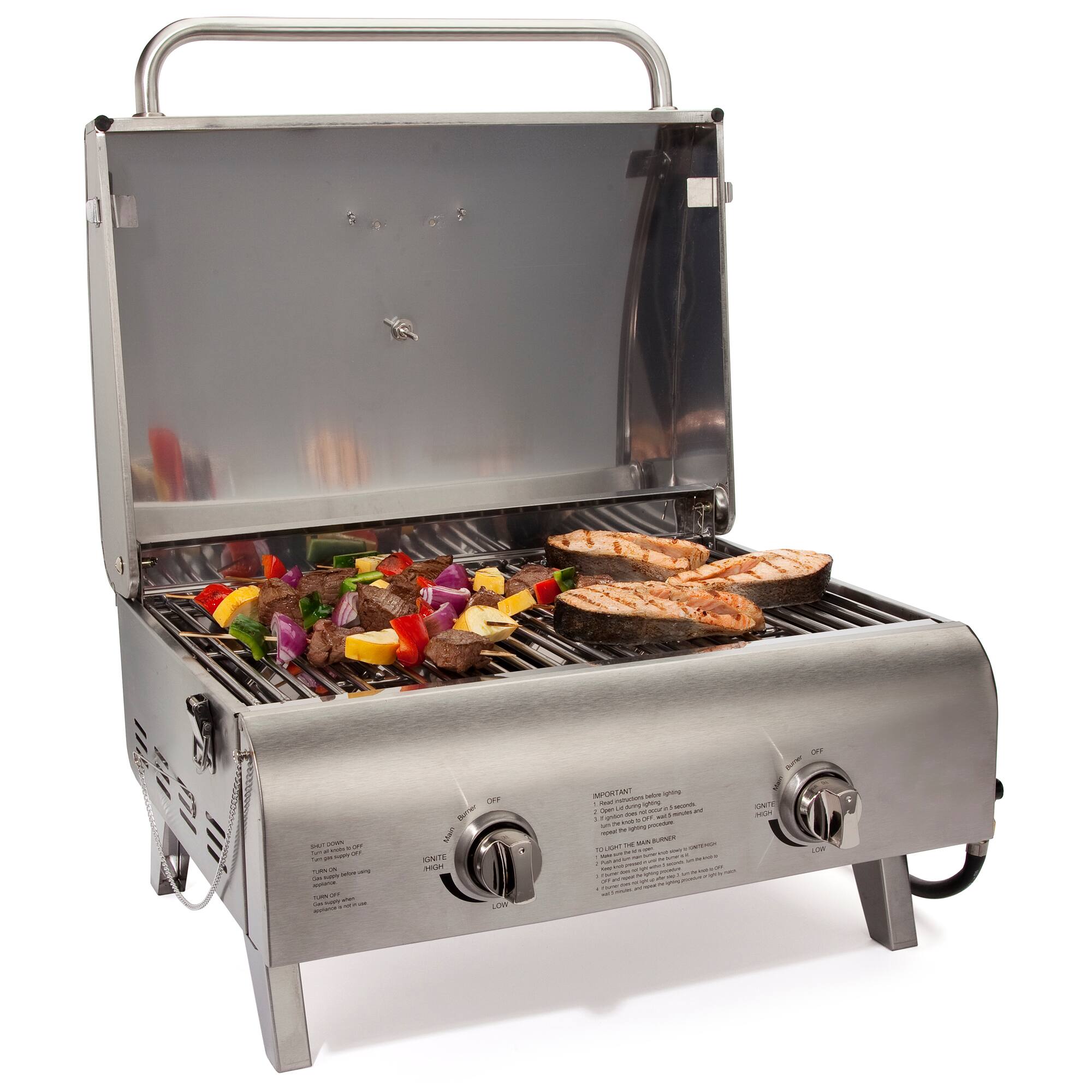 The image features a silver grill with various food items being cooked on it. There are several pieces of chicken and a variety of vegetables, including broccoli, being grilled. The grill is placed on a table, and it appears to be a small portable grill. The food items are spread out across the grill, with some pieces of chicken located closer to the front and others towards the back. The vegetables are scattered around the grill, with some pieces closer to the center and others near the edges. Overall, the scene showcases a delicious meal being prepared on a portable grill.