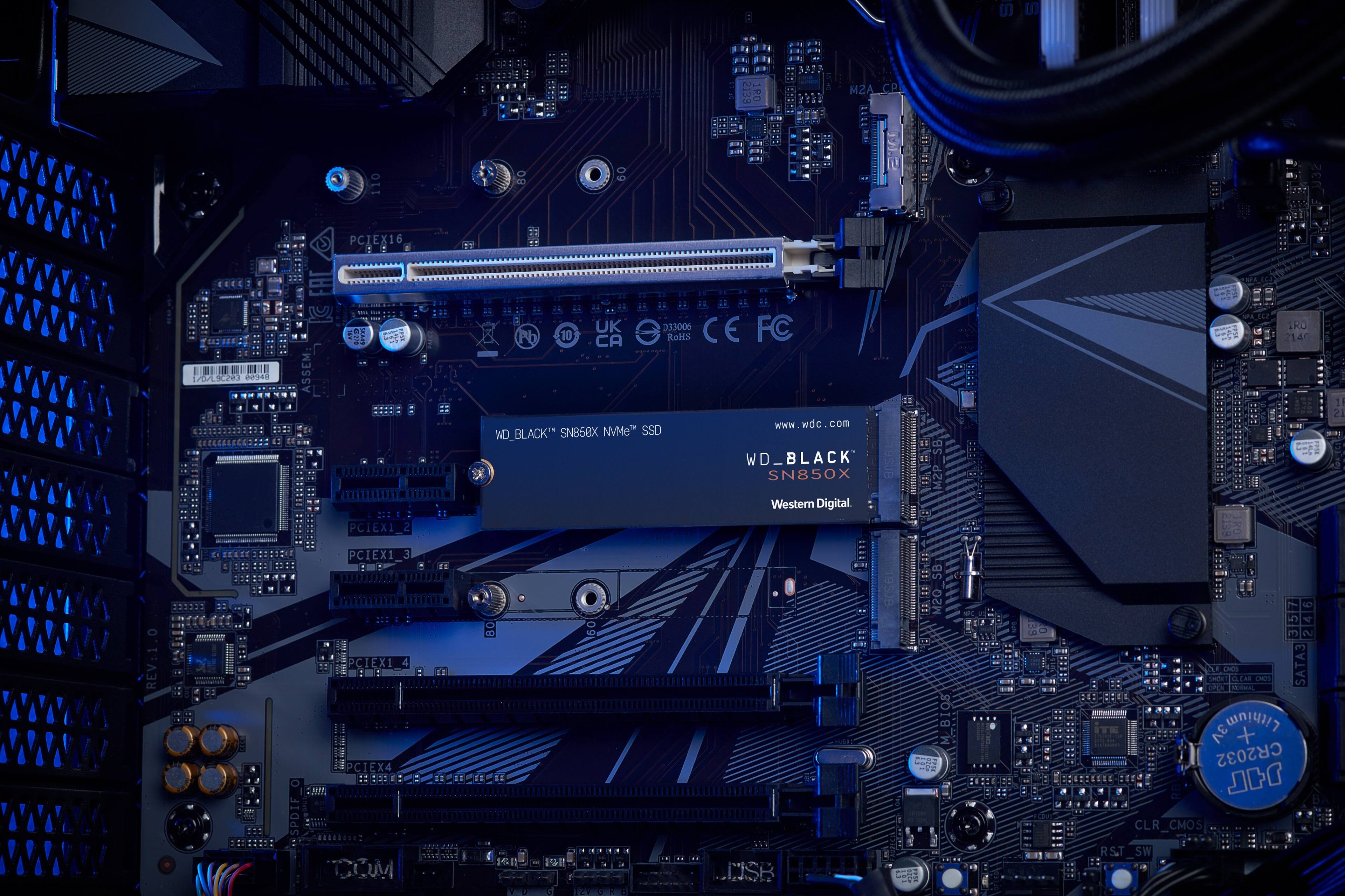 The text on the image reads: "U M2A_CP 8O PCIEX16 :1 EECC OA RONO H48 M 1 EAC ASSEM: - : UK D33006 CE FC Pb 10 CA RoMS [www.wdc.com](http://www.wdc.com) WD\_BLACK SN858X NVMe" SSD WD\_BLACK SN850X IRD 140 1 21 Western Digital PCIEX1 REV:1 E + SPDIF PCIEX1 PCIEXI e PCIEX4 MPCICIE IG 5! 60 USK SB Ce M/BIOS ... ASIE 3 246 V 2 F i LA CLEME MP SATA3 cho ntmtento  3V + CR2032 r CLR\_CMOS RST SW."